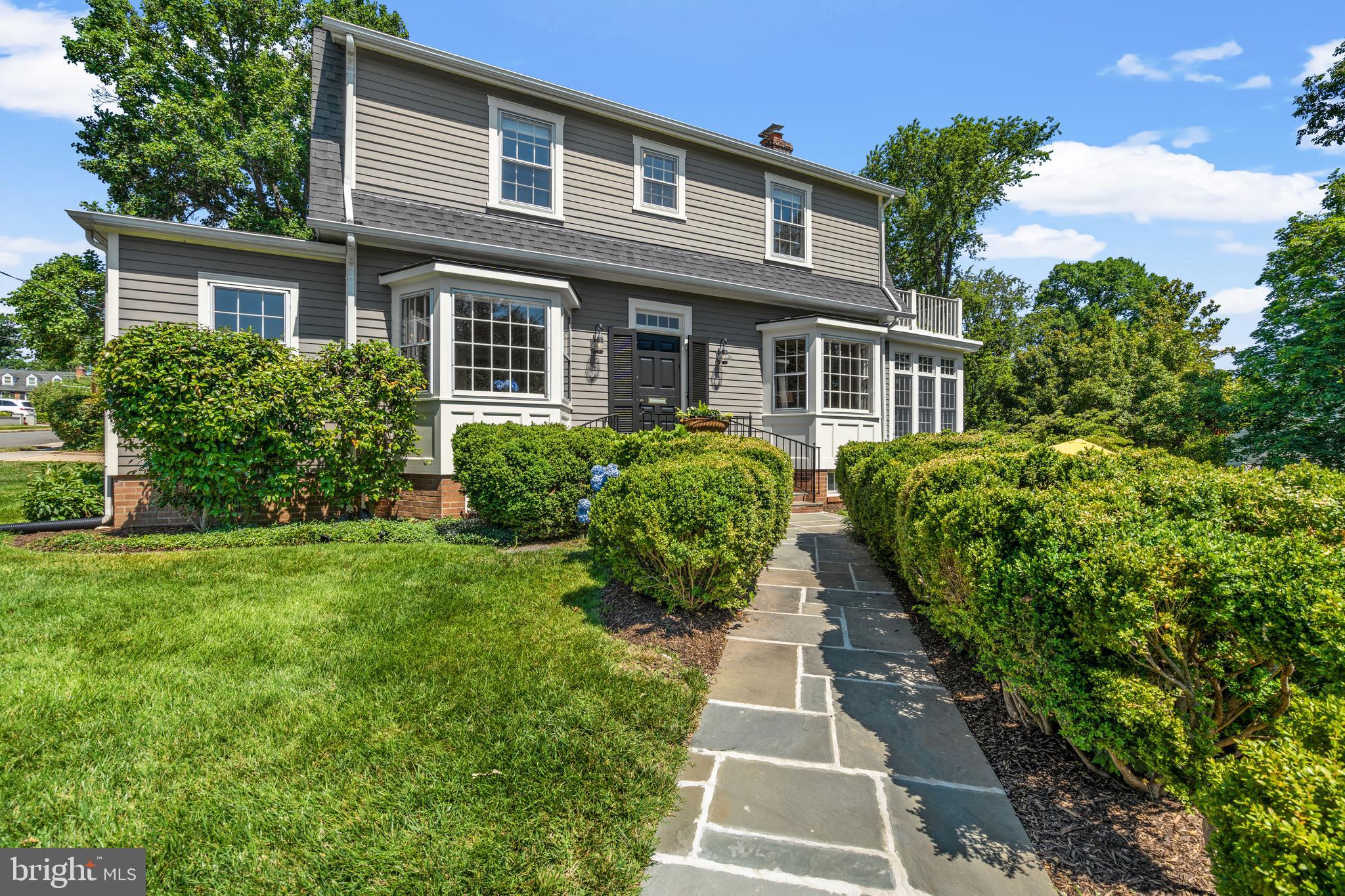 Gracious home, beautifully renovated in coveted Belle Haven! This classic architectural style Dutch Colonial sits prominently on a third acre lot overlooking the neighborhood flag and announcement circle! Generous light-filled living and dining rooms will welcome you with detailed millwork, custom built-ins, bay windows, 9 ft ceilings, fresh new designer paint colors and warm hardwood floors. Stately living room has fireplace framed with antique wood moldings plus charming bay with window seat. Renovated and expanded kitchen has Mouser inset cabinets, Bertazzoni, Wolf and Thermador appliances, large island and granite counters. Relax and recharge in sparkling sunroom addition or quiet library with lovely built-ins surrounded by your favorite books! Private hall leads to main level master bedroom, designer marble bath and additional closets. Enjoy lovely garden views from French doors that open to deck for morning coffee! Upper levels include 3 bedrooms and newly renovated bath. Second bedroom provides a roof top deck for cocktails while enjoying expansive seasonal river views! Finished lower level includes family room, half bath and bonus/guest room. Another half bath and Bosch laundry room are located off kitchen. Two car garage with attached garden room,  art studio or whatever your creative self deserves! The yard has extensive perennial plantings and underground sprinkler system. New gas steam boiler installed. Great location to Old Town and the George Washington scenic river trail! Convenient to major commuting routes, metro and airport. Exceptional home in exceptional neighborhood!