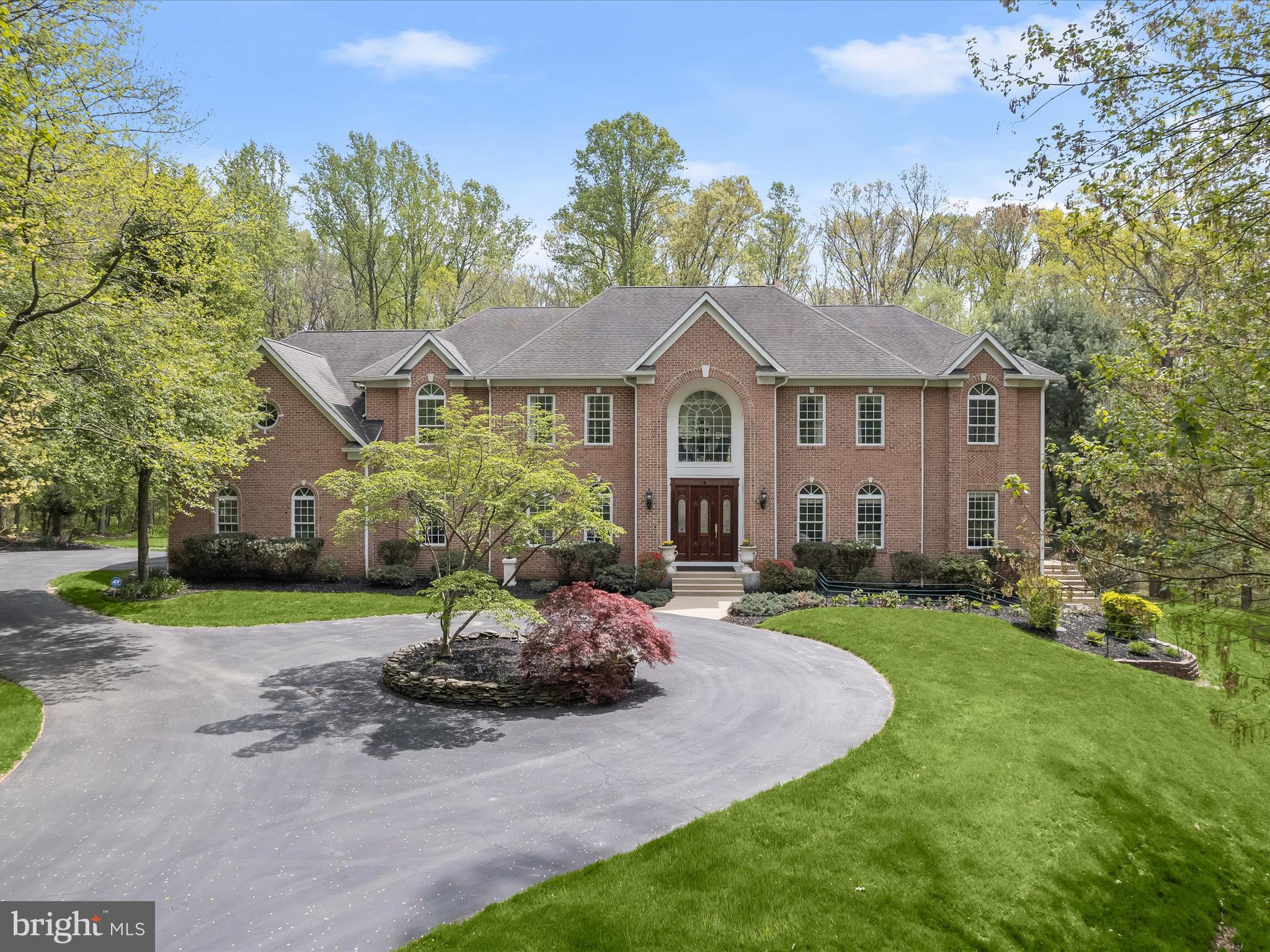 Welcome home to 8516 Edenton Court, one of the finest residences in Fulton, Maryland. This magnificent estate home is situated on nearly two secluded acres within the exclusive Beaufort Park enclave. Boasting more than 10,600 square feet of luxury living space, the seven bedroom property also features an eight-car garage, stunning in-ground pool with hot tub, theater room, in-law quarters, sunroom, multiple laundry rooms, custom trim work throughout, and so much more. You’ll enjoy serene space and privacy surrounded by a breathtaking wooded backdrop flanking the Rocky Gorge Reservoir, yet you’re still just minutes from the convenience of Maple Lawn’s bustling shops and restaurants. 

The grand two-story foyer with a large Palladian window sets the tone for elegance and sophistication. The main level features a formal living room and dining room, both adorned with trey ceilings, crown molding, chair rails, and elegant lighting. The kitchen is a chef’s dream equipped with custom cabinetry, a Wolfe 6-burner range with griddle and double oven, and a Sub-Zero refrigerator complemented by a prep sink and beverage refrigerator on the island. A spacious eat-in area opens to the upper level terrace via French doors, while a sunroom with custom windows offers stunning views of the outdoor oasis and pool. Additional amenities include two half-bathrooms and a main level laundry room/mud room. The heart of the home is the two-story living room with a gas fireplace and French doors leading out to the terrace, adjacent to the custom theater room and a spacious office.

This exquisite upper-level features a dramatic catwalk-style landing leading to a luxurious primary bedroom adorned with hardwood floors, a spacious sitting area, and an expansive walk-in closet. The primary bathroom is a spa-like retreat with a jetted tub, dual sink vanity, and elegant marble tile flooring. Two secondary bedrooms share a buddy bathroom, while the other two are served by a conveniently located hallway bathroom. The laundry room is also found upstairs. The sprawling lower level offers an additional full kitchen, a charming dining area, and a living room with multiple doors opening to the picturesque patio. The game room area offers endless fun, while a guest bedroom and a full bathroom nearby provide comfort for visitors. A luxurious guest suite with an en suite bathroom offers direct access to the pool and pool bathroom, enhancing the indoor-outdoor experience. Completing the lower level is a utility room and convenient access to the garage. A premiere offering like this doesn’t become available often and its grandeur is only fully appreciated in person. Schedule your showing today.