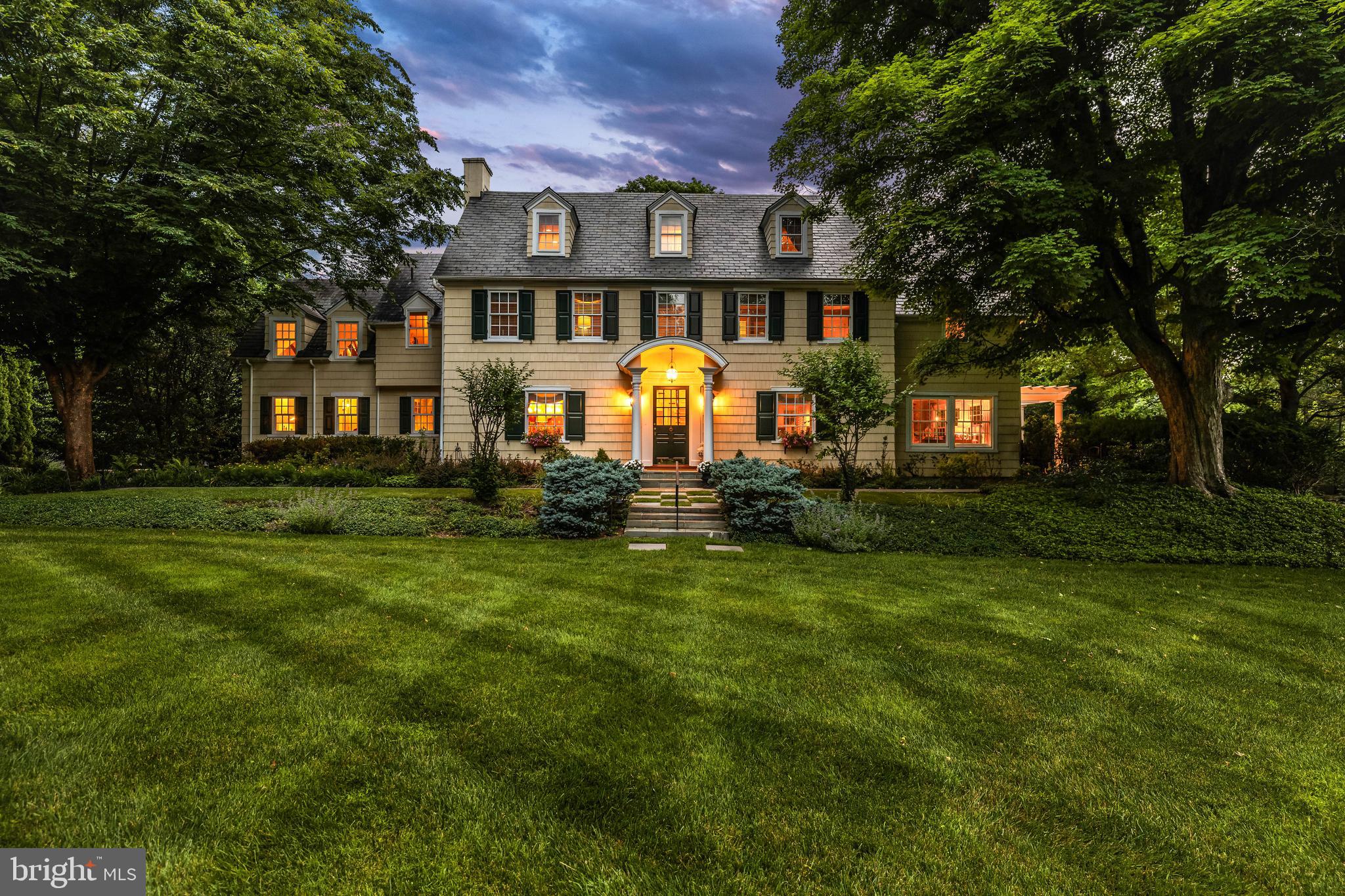 A special and rare offering, this cherished legacy home comes to market for the first time in
more than 25 years. Gracefully sited on 1.68 private acres in coveted Ruxton, this iconic 1920s
center hall Colonial embodies the very best of timeless New England architecture, seamlessly
blending historic character, exceptional craftsmanship, and sophisticated modern updates.
Behind its classic clapboard façade lies over a century of enduring charm, where elegant formal
rooms, sun-drenched gathering spaces, and thoughtful renovations create a home of remarkable
warmth and distinction. Rich architectural details—including fireplaces, custom built-ins,
coffered ceilings, exposed beams, French doors, and wide-plank wood floors—reflect the home's
heritage while providing effortless comfort for contemporary living.
At the heart of the residence is a spectacular kitchen and family room addition designed by
renowned Melville Thomas Architects. Anchored by custom cabinetry, marble countertops,
premium Sub-Zero and Wolf appliances, and a generous center island, the kitchen opens
seamlessly to inviting family spaces designed for both everyday living and grand-scale
entertaining. The dramatic family room, with its soaring ceilings and stacked-stone fireplace, connects beautifully to brick terraces and landscaped gardens, creating a seamless indoor-
outdoor lifestyle. The residence offers six bedrooms, four full baths, and two half baths across four finished levels. The primary suite is joined by multiple secondary bedrooms, while the charming third
floor provides private guest accommodations and a delightful reading nook. A finished lower
level with recreation room, kitchenette, powder room, and extensive built-ins adds exceptional
flexibility for today's lifestyle. The grounds are equally captivating. Mature, professionally-designed gardens and specimen plantings, expansive lawns, stone retaining walls built by Donofrio & Sons, classic picket fencing, and terraced brick patios with pergolas create a picturesque setting rarely found today.
Two detached garages, an unique feature in Ruxton, further enhance the home's appeal—one
featuring a finished second-floor art studio and the other offering unfinished upper-level space
ready for customization. An extra-wide driveway accommodates ample guest parking.
Meticulously maintained and substantially improved, the property benefited from a
comprehensive renovation by Melville Thomas Architects in 1999, including all new systems,
followed by a significant kitchen and service wing expansion in 2006, also designed by Melville
Thomas. Recent enhancements include a genuine slate roof installed in 2021 and a whole-house
generator. A treasured home of uncommon beauty, history, and provenance, this is a once-in-a-generation
opportunity to acquire one of Ruxton's most beloved properties—a timeless home where
architectural integrity, modern livability, and enduring legacy come together in perfect harmony.