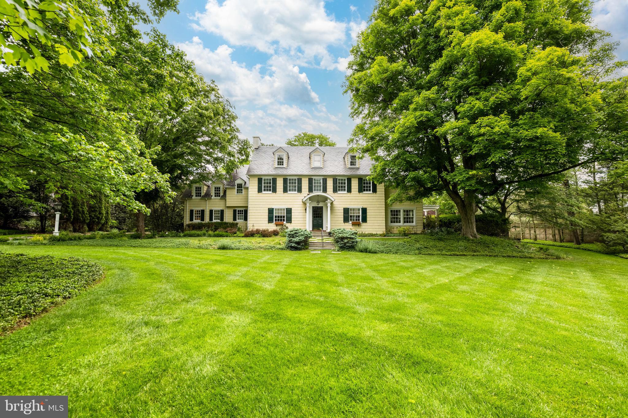 Coming Soon...Classic 1920s center hall Colonial brimming with New England charm, this gracious clapboard residence blends timeless architectural craftsmanship with thoughtfully updated living spaces. Set on a beautifully level 1.68-acre  lot in coveted Ruxton, the home offers six bedrooms, four full baths, and two half baths, with elegant formal rooms balanced by warm, comfortable gathering spaces throughout. Traditional living and dining rooms retain the home’s classic appeal. The living room showcases  a fireplace, built-ins, and direct access to the sunroom, surrounded by walls of windows that fill the space with natural light.. A stunning 2006 kitchen addition serves as the heart of the home, featuring trussed  ceilings with exposed beams, custom shaker style cabinetry, marble countertops, wood floors, a large center island plus the breakfast area with coffered ceiling adding warmth to the space. The expansive central landing overlooks the family room and is complemented by a well appointed wet bar and butler's pantry. Step down into the sun-filled family room which is anchored by a dramatic stacked-stone fireplace, wide planked wood floors and has access through French doors out to the patio, creating the perfect indoor-outdoor flow, for everyday living and entertaining. The second floor features the primary suite along with three additional bedrooms and two baths, a secondary staircase plus the conveniently situated laundry. The cozy third floor offers two more bedrooms, a full bath, and a charming cubby ideal for a reading nook. The finished lower level provides exceptional flexible space with a recreation room, kitchenette, powder room and walls of built-ins perfect for books, games, and storage. Outside, the property is rich with charm and privacy, featuring stone retaining walls, the classic picket fence, terraced brick patios with pergola and expansive lawns framed by mature landscaping. Two detached garages, provides exceptional versatility - one with a finished second level art studio and the other with unfinished upper level space offering endless possibilities plus an extra wide driveway providing ample parking. There were 2 renovations: in 1999, a complete renovation designed by Melville Thomas Architects, with all new systems.  In 2006, Melville Thomas Architects also did the kitchen, wet bar, service pantry addition with Sub-Zero  &  Wolf  appliances and Marvin windows.  Additional highlights include a 2021 slate roof and a whole-house generator.  Warm, welcoming and filled with character at every turn, this exceptional property offers timeless appeal with the comfort and functionality of modern living.