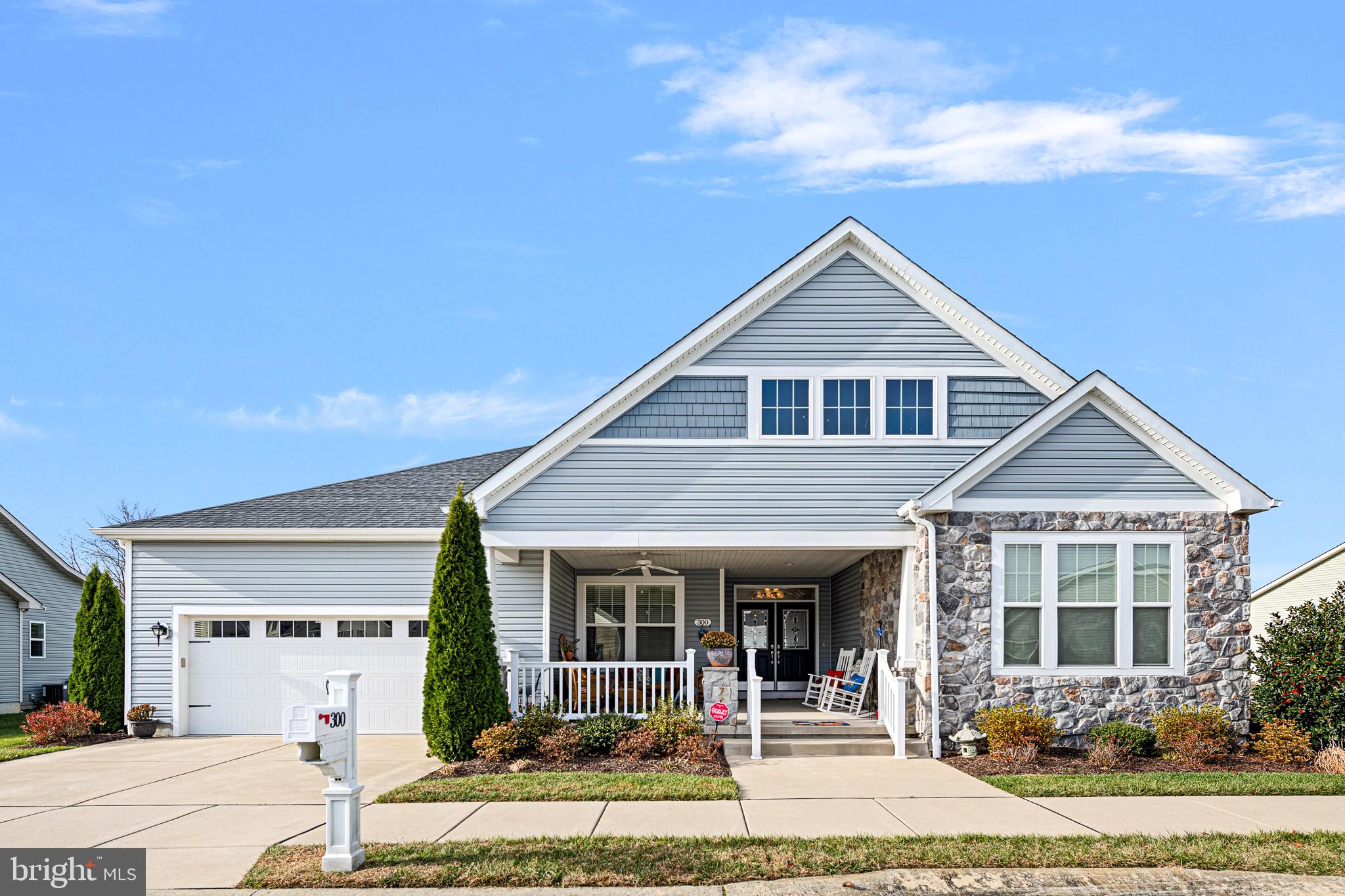 Beautifully upgraded home on a large, private corner lot in the award‑winning Nobles Pond 55+ community. This rare floor plan—one of only two in the neighborhood—offers exceptional space, comfort, and architectural appeal. Enjoy a 20x20 covered front porch, a rear deck with automatic retractable awning, and a spacious patio with electric ready for a hot tub. The private yard backs to peaceful views of the pond and gazebo, creating a serene outdoor retreat. Inside, a dramatic 19x8 foyer, crown molding, tray and vaulted ceilings, and four ceiling fans add elegance throughout. The home features 3 bedrooms and 3 full baths, including a private en‑suite for Bedroom 2. The primary suite includes a walk‑in closet with organizer, jetted walk‑in tub, and ceramic walk‑in shower with waterfall heat and handheld multi‑pressure head. Storage is abundant with multiple pantries, a drop zone, butler’s pantry, and a 2‑car garage with built‑ins and overhead storage. Tankless hot water and all appliances included. Nobles Pond offers resort‑style amenities including clubhouse, fitness center, saltwater pool, pickleball, bocce, putting green, garden plots, walking trails, and a full activity calendar. A truly exceptional home and lifestyle.