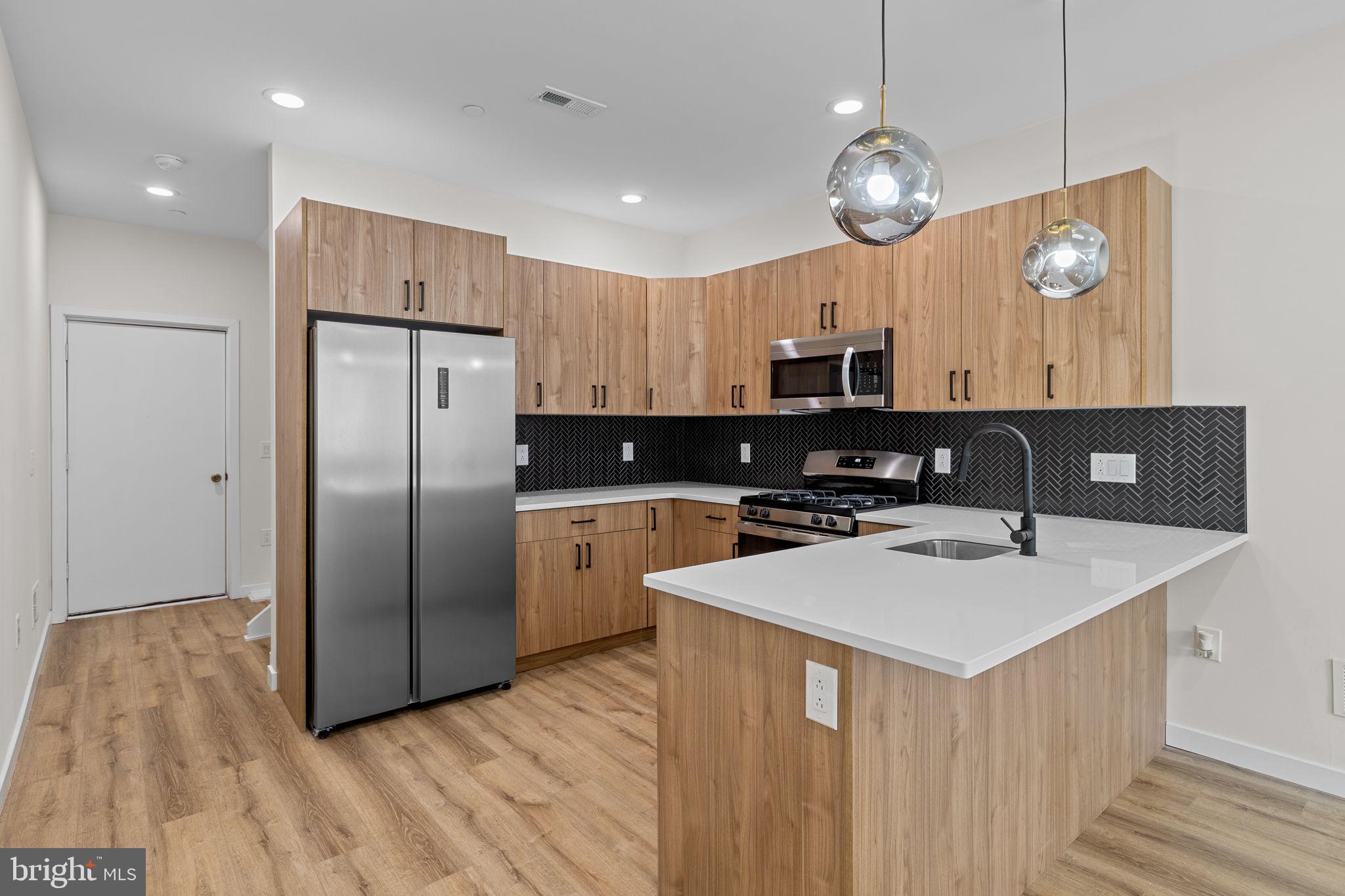 Don't miss the incredible value in this recent new construction home featuring roof deck and tax abatement UNDER $350,000! Enter to a spacious main level with living room and open kitchen, white shaker cabinets and abundant countertop and storage space. This unique floor plan is well-suited for privacy with a bedroom and full bath on three levels. For example, the second floor features a laundry room, full bath and only one spacious bedroom for privacy and additional space. On the third floor, a primary bedroom suite fills the entire level with a walk-in closet, walk-in shower, separate tub, double vanity sink, and another spacious bedroom. In the basement, a third bedroom and third full bathroom could easily be converted to work from home space or home gym. Don't miss the roof deck or rear patio perfect for outdoor cooking. Approximately 5 years remaining on a full, 10 year property tax abatement. Convenient to SEPTA transit, Center City, and Fairmount Park. Schedule your private showing today!