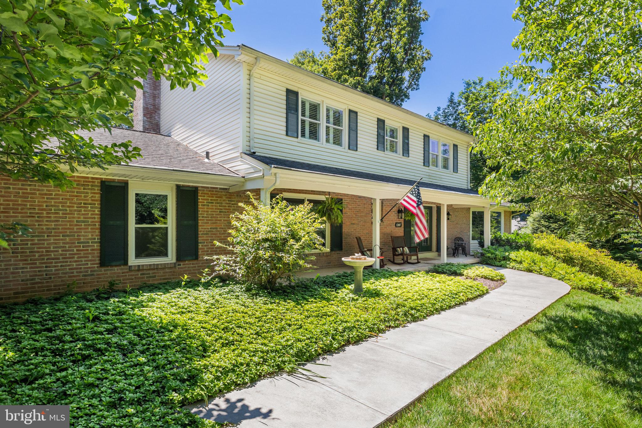 Tucked at the end of a quiet cul-de-sac on a .83-acre wooded lot, this 4,515 sq. ft. brick Colonial is one of South Reston's most meticulously maintained and comprehensively upgraded homes. Inside, this one delivers on every level — literally. The main floor flows with hardwoods throughout a formal living room, dining room, and an updated kitchen with SubZero refrigerator, double ovens, double sinks, custom inset cabinets and a walk-in pantry. A generous family room features a refurbished fireplace and views of the meticulously landscaped backyard. Additionaly you will find two powder rooms, a mudroom and a dedicated office on the entry level. Upstairs the primary suite impresses with an enormous walk-in closet, in-suite laundry, and expansive bath with soaking tub, shower, separate toilet room and double vanity The upper floor also features two additional bedrooms and a hall bath. The fully finished walkout lower level is not to be missed. This floor adds two large rec rooms, a 2nd wood-burning fireplace, a 3rd full bath, a fifth legal bedroom, and direct patio access to the lush landscaped grounds. An 2-car garage with sauna, driveway parking for 4 addtional vehicles and a rare central vacuum complete the offering. Zoned for three highly regarded Fairfax County Public Schools and steps from 55 miles of trails, 15 community pools, tennis courts, playgrounds; the location alone is second to none. Add in quick access to Reston Town Center's dining and shopping, the Silver Line Metro, commuter routes, and this is Northern Virginia living at its absolute finest.  This one is a gem. Don't believe me? Book a tour and see for yourself before someone else calls this one "home".