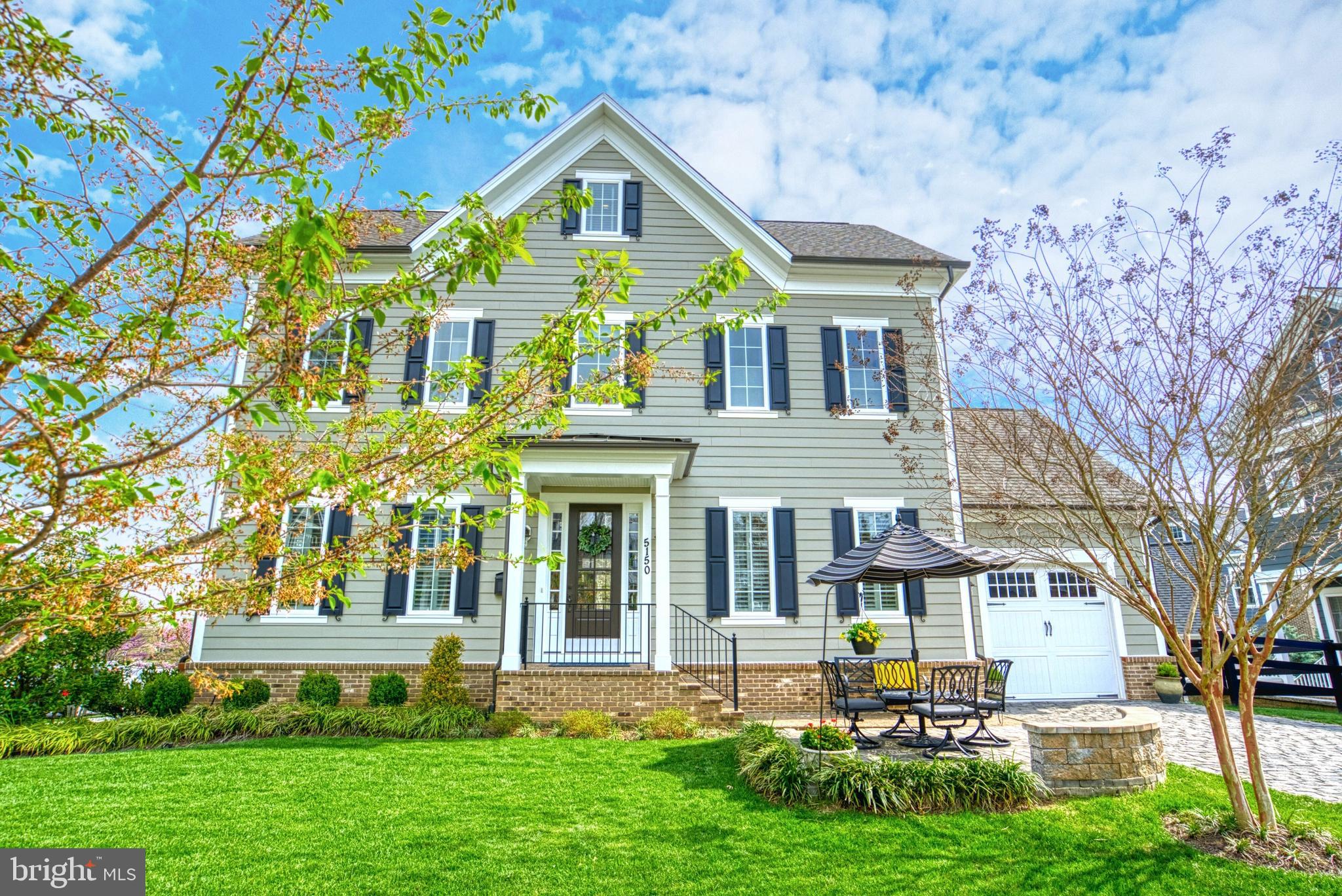 Fantastic new price -- get in just in time for 4th of July fireworks and neighborhood fun!!  This coastal colonial, a Charleston-inspired design and build by locally-based Evergreene Homes, is conveniently located in a fun neighborhood just a short distance from the Rosslyn/Ballston corridor. The 4 levels boast an efficient yet gracious floorplan with ample flex space between both a finished loft and lower level -- plenty of room for visiting family, home & work spaces to entertain and house an au pair or in-law!   There are 3 off-street parking spaces -- the generous paver driveway leads to the oversized one-car garage (great storage!) and allows for entrance into a tucked-away mud room... A perfect, out of the way drop-zone! Though modern construction and a semi-open floorplan, bygone charm abounds with wood floors on the main and one upper level, high ceilings and tall doorways and windows, 7â baseboards, 2-piece crown and chair rail molding and shadow boxing in the dining room. The gourmet kitchen boasts ceiling-height cabinets (42" plus another 21") with posh crown moldings and luxury glass door fronts -- the modern conveniences mean a huge Quartz center island, 36â wide counter-depth French door refrigerator and 6-burner gas cooktop along with ample recessed lighting. The exquisite living room offers a coffered ceiling and commanding fireplace flanked by built-in shelves and cabinets. The charming primary suite with a tray ceiling and fan, two walk-in closets and a luxurious bathroom with an elegant tub and separate frameless glass shower enclosure, a private WC, dual vanities and Timberlake cabinets make for a special retreat. The vast 4th level includes a loft area as well as a bedroom and full bathroom. The lower level hosts a 5th bedroom and dual entry full bathroom, as well as a recreation room, den (currently a home gym) and storage area. Outside, al fresco dining can be enjoyed from the recently added paver patio with knee wall and lovely surrounding landscaping all overlooking the most expansive, greenest, lushest lawn in the neighborhood!  The HOA offers the option to fence the front yard. There are two fantastic parks and a hiker / biker trail a stone's throw from the home and Metro is just a few blocks away. This is a very special and beautifully maintained home!
