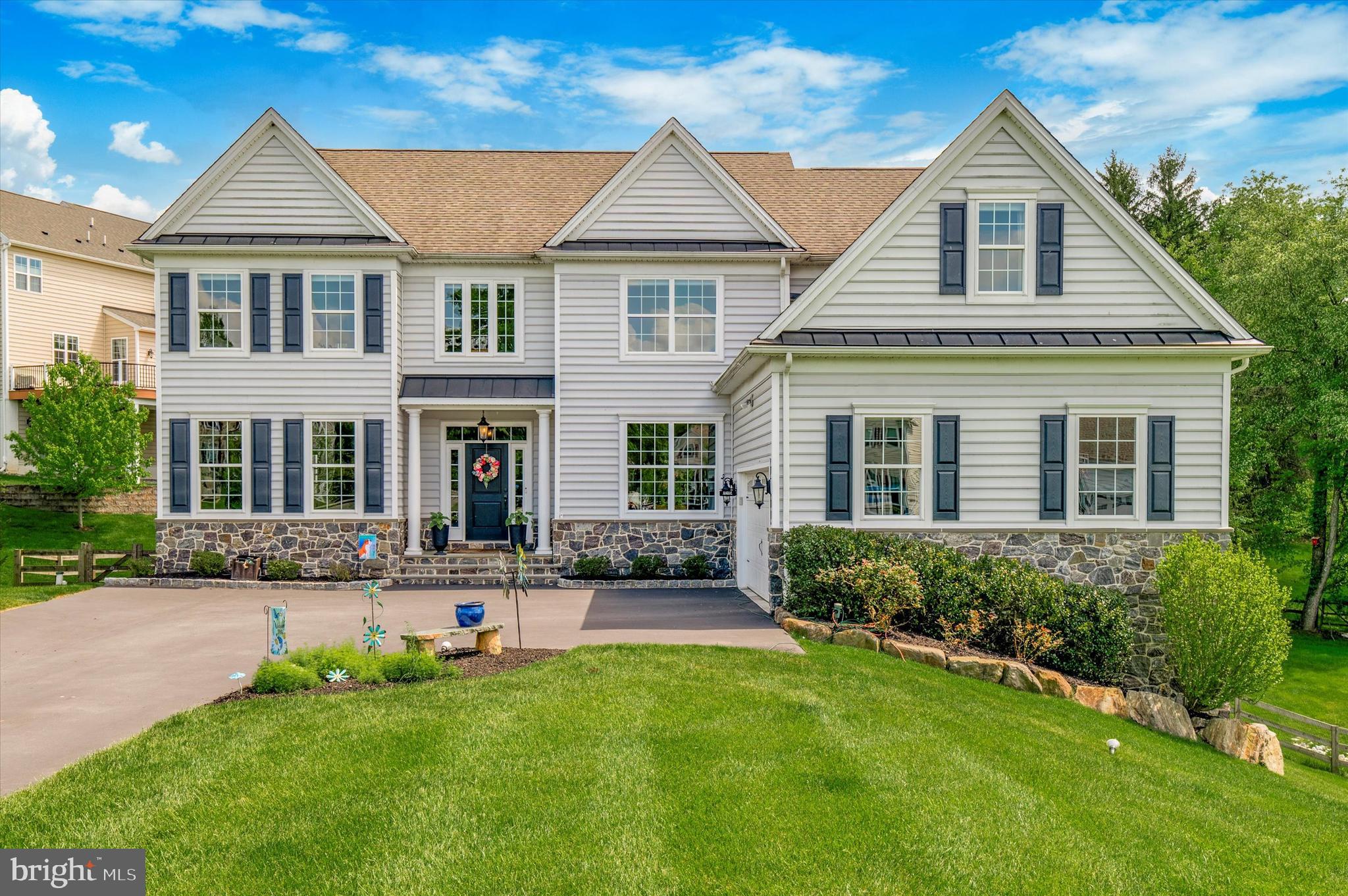 This is the one you’ve been waiting for! This stunning center hall has it all! Situated at the end of a cul-de-sac and neighboring community open space, this four bedroom home is just a short five minute drive to popular West Chester Borough. Bright and airy with neutral decor this home is beautifully appointed with extensive trim detail and wide-plank wood flooring throughout. A perfect blend of traditional with contemporary features active homeowners desire. The elegant living room and dining room flank the sun-filled foyer. The accessible yet private first floor office is separated by glass French doors bringing in an abundance of natural light. A grand two story family room features a gas fireplace with slate surround and opens to the combination kitchen and breakfast room. Featuring white perimeter cabinets and accented by a wood island, the kitchen features quartz countertops and is appointed with GE Profile stainless steel appliances, including a five-burner gas cooktop with glass exhaust hood and a built-in wall oven and microwave. A Bosch dishwasher and oversized stainless steel undermount sink are accented with a view to the deed restricted open space adjacent to the property. The large island is convenient for an easy breakfast, casual dinners or a full entertaining buffet! Glass cabinets are the focal point of the butler’s pantry which features a built-in wine/beverage refrigerator. A large walk-in pantry closet with open shelving is perfect for dry goods and additional storage of countertop appliances. The large breakfast room boasts a triple window overlooking the neighboring open space and a sliding glass door with transom leading to the composite deck. The second story deck features handsome back vinyl rails and steps to the fenced rear yard. The mudroom, conveniently located off the two car courtyard entry garage, features easy to clean bead-board walls, a long bench with four cubbies and plenty of hooks for coats, backpacks and keys. A front and back staircase both with wood treads and open handrails lead to the second floor of this home. Four generously sized bedrooms all feature a ceiling mounted light fixture or junction box for future ceiling fan. The luxurious owner’s suite has a separate sitting room, tray ceiling, his and her closets and an ensuite bath complete with large glass enclosed shower, soaking tub, private commode and dual vanities. The guest bedroom has two sets of double closets and access to the hall bath. The third bath adjoins two bedrooms with a private commode and shower area, a large vanity with dual sinks and a linen closet. The front bedroom accesses a finished bonus room with vaulted ceiling and walk in closet which is perfect as a playroom, additional office, exercise room, sewing or craft room or just about anything imaginable. The conveniently located laundry room with built in laundry tub with base cabinetry completes the second floor. Boasting two sets of double windows, a sliding glass door and 9’ ceilings, the finished basement is the icing on the cake! A convenient second powder room is already plumbed for a future shower if desired. There is plenty of additional storage in an unfinished area with built-in shelving units. This home is not to be missed! Come see this cul-de-sac dream with decorative stone belt and Belgium block accents, landscape boulders, standing seam metal roof details and maintenance-free beaded siding before it’s too late!
