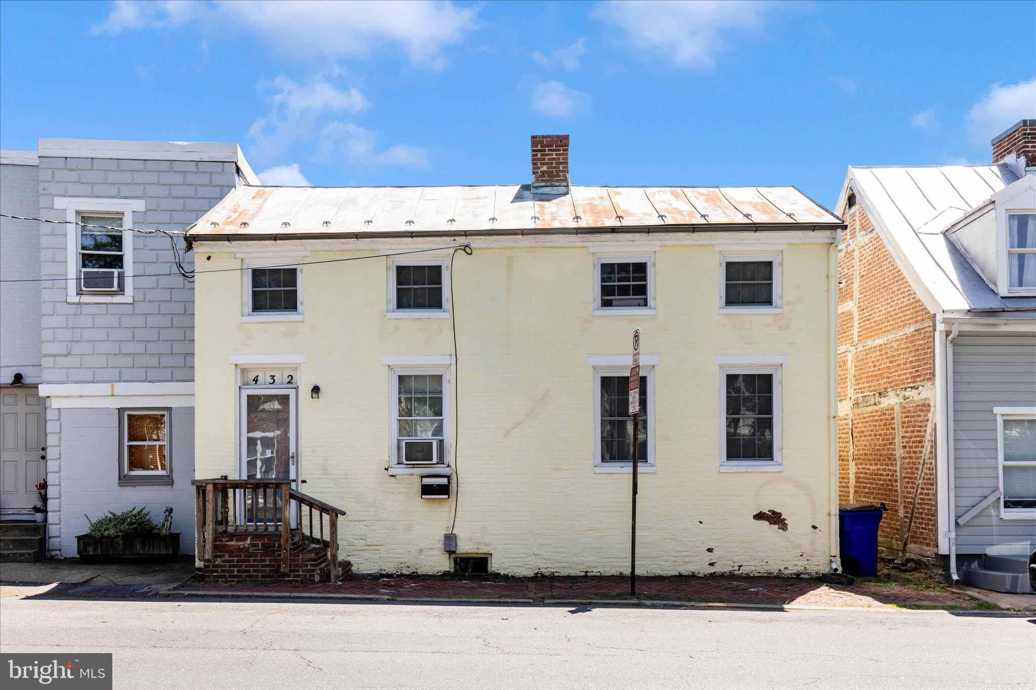 LOCATION and POTENTIAL.  This fixer-upper is ripe for the picking for the right person to see its potential.  If you have a creative eye for design and spaces, this house will speak to you.  Such a unique layout and piece of property in Downtown Frederick.  It's double wide compared to most rowhomes in Downtown.  Main level has a living room, kitchen with fireplace, an added room off of living room, small bedroom and full bath.  Off the back is an enclosed room that is just waiting for someone to do something with it.  This main level could be reimagined to be FABULOUS.  The upper level offers two small rooms that make darling bedrooms.  The back yard could be an absolutely delightful little courtyard with the right imagination.  No off street parking, but street parking is readily and usually available.  A stones throw to Baker Park, Market Street and all downtown has to offer.  This is a prime location and would make a fantastic Air B&B or pied-à-terre.  Bring your plans and your creativity and make this little gem shine.
