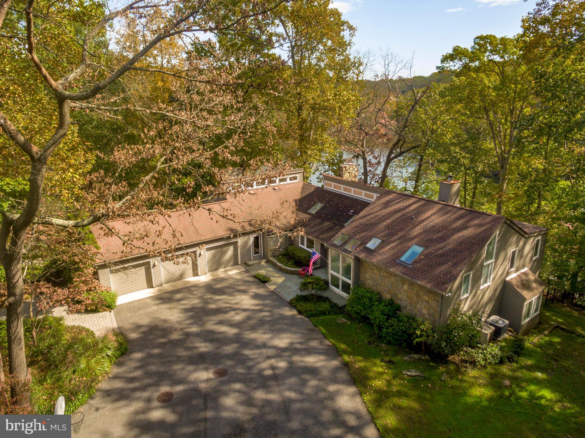 Waterfront, private contemporary home with a gorgeous pool, decking, gazebo, protected deep water on Hopkins Creek. Gated community of Bayberry Hills offers a unique combination of a serene natural  setting with large lots, nature lovers' paradise, an easy commute to all major routes, plus all conveniences close by. This Acorn Deck home, with it's open living space, has been the perfect spot for family gatherings and entertaining. There are 3 fireplaces, multiple decks, water views from almost every room, a fabulous office with water views, 3 car garage and mud room. The Kitchen is centrally located with the right amount of work space, large pantry, bar area, table/chairs and granite island. Living Room w/stone fireplace, open Dining Room is spacious and the Family Room is located for easy access to the pool and decking....waterviews from all of these rooms. The Primary Bedroom is private with lovely views, private deck, walk in closet and extra storage by spiral stairs to space above closet. Primary Bathroom has double sinks, soaking tub, stall shower....lovely light in this room from skylight. Open loft area is a great office with water views.  Laundry, full bathroom and bedroom 2 are on one level and the lower level has a Great Room, full bathroom and two large bedrooms. It's all right here.....wait until you see it!