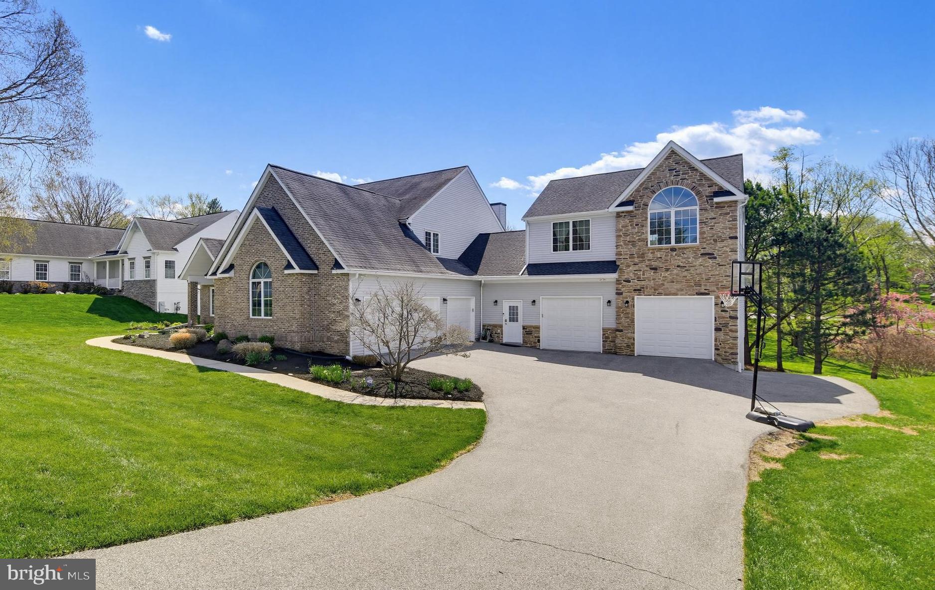 Price improvement! Exceptional custom residence offering over 6,000 finished square feet, a rare 5-car garage, and an outstanding location in highly desirable Patapsco Park Estates within the sought-after Mt. Hebron High School district. This distinctive home combines space, functionality, and convenience in a way that is rarely available in Ellicott City, providing estate-style living without sacrificing proximity to major commuter routes, shopping, dining, parks, and everyday conveniences.

Designed for both entertaining and comfortable daily living, the home features hardwood flooring on two levels, generously sized living areas, an updated gourmet kitchen with premium finishes, dramatic dual-sided fireplace, finished walkout lower level with theater/media space and wet bar, and an impressive 663-square-foot TimberTech composite deck with integrated lighting. Abundant windows fill the home with natural light while thoughtfully designed spaces create warmth, character, and flexibility throughout.

Car enthusiasts, collectors, hobbyists, and buyers seeking exceptional garage and storage capacity will immediately appreciate the rare 5-car garage and expansive driveway parking—features seldom found this close to the heart of Ellicott City. Whether hosting gatherings, pursuing hobbies, working from home, or simply enjoying extra space, this property offers a lifestyle that is difficult to duplicate in today's market.

A private upper-level 2-bedroom suite provides additional flexibility for guests, extended stays, home office space, fitness room, creative studio, or other evolving lifestyle needs. Rare opportunity to own a one-of-a-kind custom home offering space, convenience, garage capacity, and long-term value in one of Howard County's most desirable communities.