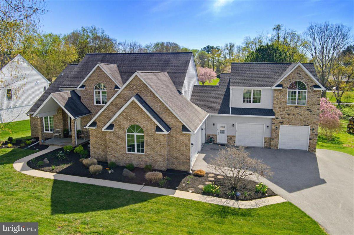 Price improvement! Exceptional custom residence offering over 6,000 finished square feet, a rare 5-car garage, and an outstanding location in highly desirable Patapsco Park Estates within the sought-after Mt. Hebron High School district. This distinctive home combines space, functionality, and convenience in a way that is rarely available in Ellicott City, providing estate-style living without sacrificing proximity to major commuter routes, shopping, dining, parks, and everyday conveniences.

Designed for both entertaining and comfortable daily living, the home features hardwood flooring on two levels, generously sized living areas, an updated gourmet kitchen with premium finishes, dramatic dual-sided fireplace, finished walkout lower level with theater/media space and wet bar, and an impressive 663-square-foot TimberTech composite deck with integrated lighting. Abundant windows fill the home with natural light while thoughtfully designed spaces create warmth, character, and flexibility throughout.

Car enthusiasts, collectors, hobbyists, and buyers seeking exceptional garage and storage capacity will immediately appreciate the rare 5-car garage and expansive driveway parking—features seldom found this close to the heart of Ellicott City. Whether hosting gatherings, pursuing hobbies, working from home, or simply enjoying extra space, this property offers a lifestyle that is difficult to duplicate in today's market.

A private upper-level 2-bedroom suite provides additional flexibility for guests, extended stays, home office space, fitness room, creative studio, or other evolving lifestyle needs. Rare opportunity to own a one-of-a-kind custom home offering space, convenience, garage capacity, and long-term value in one of Howard County's most desirable communities.