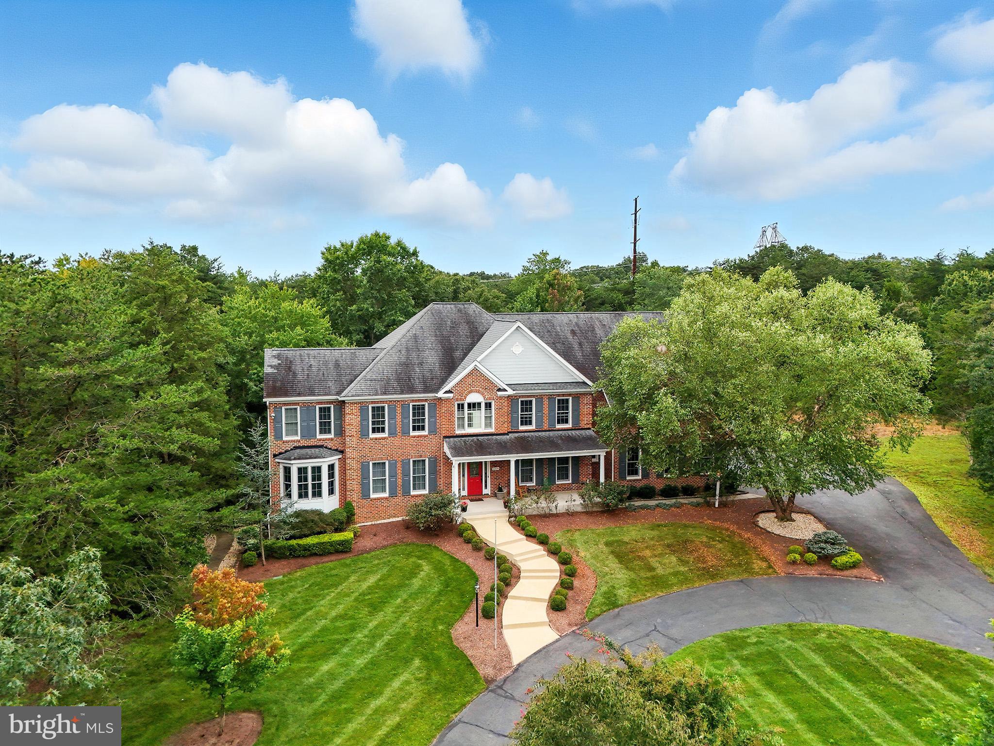 Private Oasis with Custom Touches and Over-the-Top Amenities!
Tucked away on a private cul-de-sac with only four custom homes and no HOA, this stunning 7,080 sq. ft. retreat sits on 5 peaceful, wooded acres—your own private slice of nature. Whether you're sipping coffee on your private upper deck off the owner’s suite— or unwinding on the expansive main-level deck with screened porch, outdoor fireplace, and gazebo, this home was built to be enjoyed inside and out.
Step inside and you'll find thoughtful luxury everywhere: four fireplaces, real hardwood floors on the main and upper levels, two full laundry rooms (yes—two!), and a gourmet kitchen with granite counters, huge island, walk-in pantry, and room to entertain or cook up a storm. The two-story family room is made for relaxing or hosting, with French doors leading out to the deck, and there’s even a wet bar for game day.
Upstairs, the owner's suite feels like a high-end hotel: fireplace, sitting area, snack-and-coffee station (with full-size fridge and microwave!), oversized bath with jetted tub, walk-in shower, dual vanities, multiple walk-in closets, and a spacious dressing area with a 3-way mirror. Each of the other bedrooms has direct or private bath access, so no one’s left out when it comes to comfort. Plus the secondary suite includes a sizable sitting area creating a true retreat for relaxing or enjoying a quiet moment.
The walk-out lower level brings on the fun—huge rec and game rooms (think movie nights or pool tournaments), a wet bar, plus a fifth bedroom and full bath. Still need storage? The unfinished area gives you over 400 sq. ft. of space for everything else.
Extras? Of course. 3-car garage. Irrigation system. Standby generator. Solid wood doors. Pocket doors. Super-efficient HVAC (4 zones!) and foam insulation for lower bills.