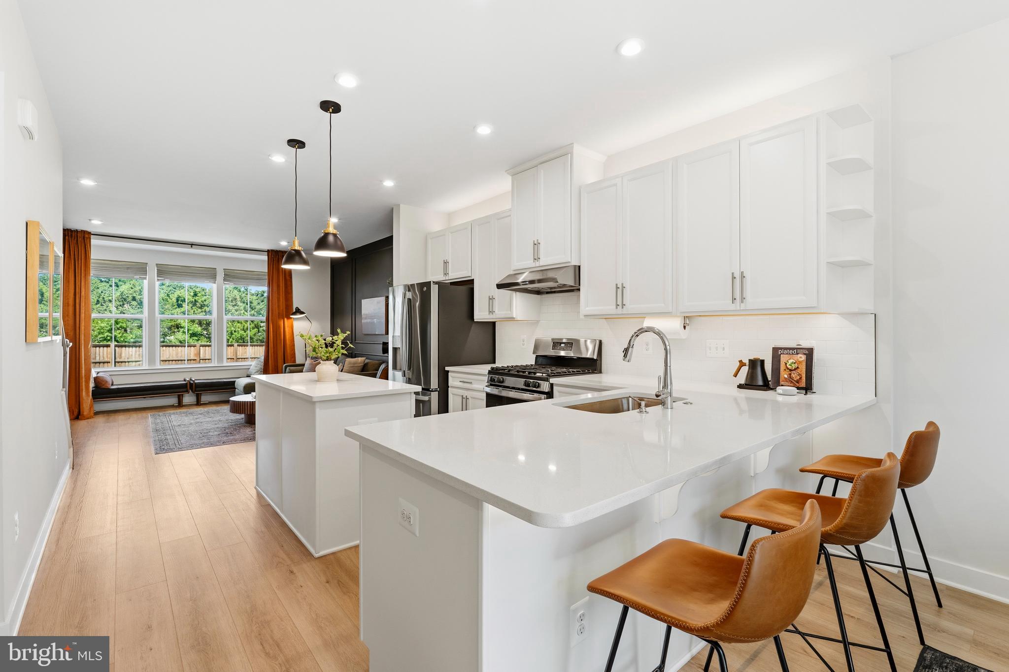 Experience Modern Luxury in the Dulles Tech Corridor! Nestled in the highly sought-after Foster’s Glenn community, this immaculate 3-level, 3-bedroom, 3.5-bathroom townhome perfectly blends contemporary design with ultimate urban convenience. Boasting over $24,500 in premium owner updates, this turn-key residence offers a rare and versatile layout featuring a coveted main-level bedroom and full bath—ideal for a private home office, long-term guests, or multi-generational living.

Step up to the sun-drenched main living space where high-end design takes center stage. The open-concept kitchen and dining area are highlighted by custom designer touches, including an accent wood-paneled wall, an elegant dining chandelier, modern pendant lighting, and professional-grade LED above/under-cabinet illumination. The kitchen features an upgraded stainless steel under-cabinet exhaust hood and a seamless air-switch disposal. Directly off the main living area, step outside to relax or entertain on your generous private balcony.

The upper level serves as a private retreat, completely transformed with custom matching resilient flooring running seamlessly through all three bedrooms, hallways, and walk-in closets. Experience a touch of luxury with automated features, including high-end blinds, custom wood accent molding, a floating media display, automatic LED stairwell illumination, and motion-sensor switches in the custom-painted walk-in closets.

Practicality meets innovation on the lower level, featuring a pristine 1-car garage complete with protective floor sealant, custom LED strip lighting, motion-sensor switches, and a premium ultra-silent Smart garage door opener (equipped with automatic locks and power-outage backup). Additional peace of mind is provided by a pre-installed smart security camera system and a high-efficiency washer/dryer set.

Unbeatable Location & Commuter's Dream: Positioned less than 1.5 miles from the Innovation Center Metro Station (Silver Line) and just 3 miles from Dulles International Airport, your commute into Reston Town Center, Tysons, and Downtown D.C. is effortless. Enjoy rapid access to Rt. 28, the Dulles Toll Road, premier shopping, dining, and top-rated Fairfax County schools. Welcome home to precision, style, and total convenience!