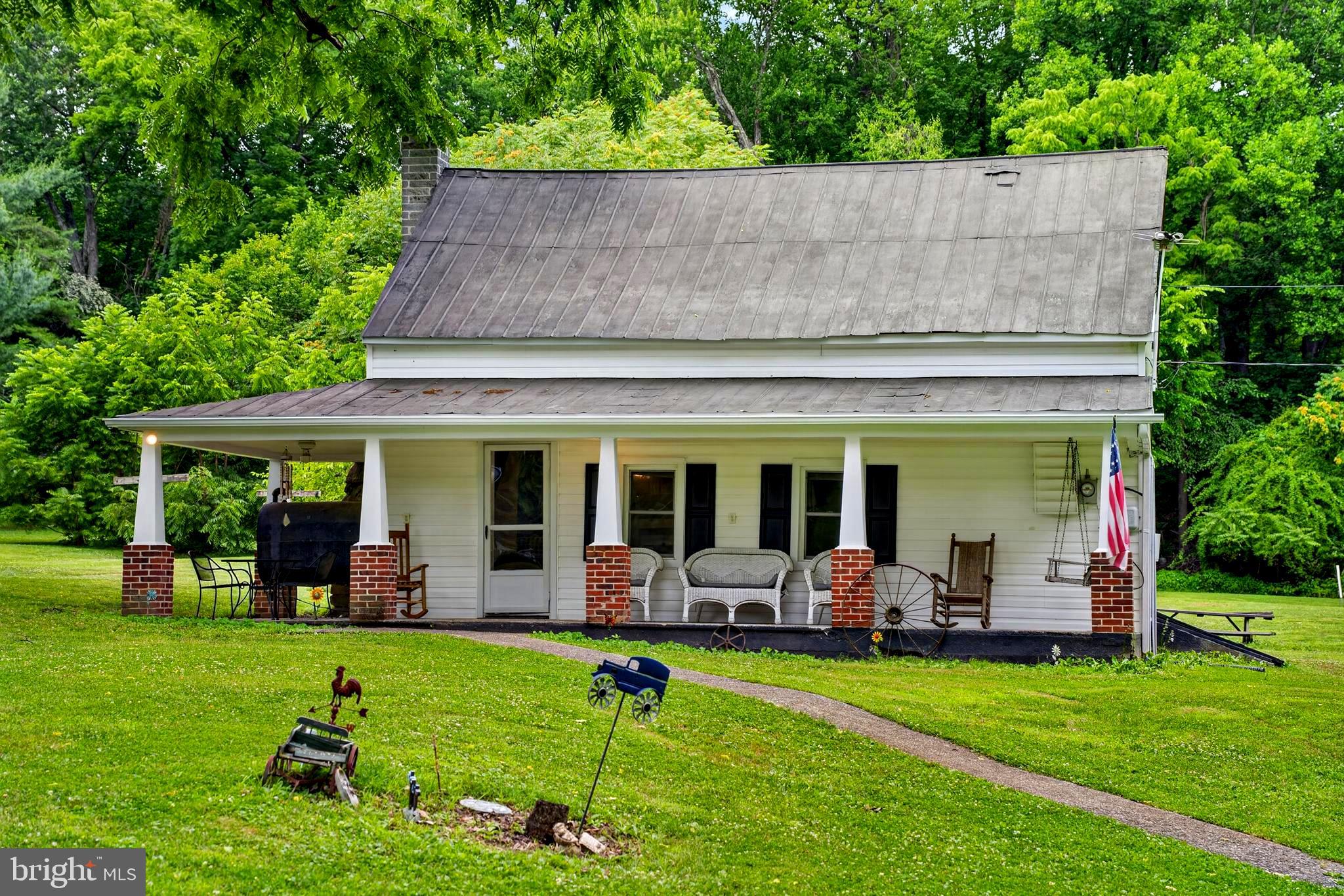 13320 Catoctin Furnace Road features a Circa-1800 partial log home with three bedrooms and two full bathrooms situated on 1.6 acres in the historic Catoctin Furnace area of Thurmont. The property includes a covered front porch, deck, detached garage, storage shed (2024), spacious yard, and a seasonal stream along the rear portion of the lot.

Seller improvements include newer siding, replacement first-floor windows, all new plumbing installed in 2016, water heater replaced in 2022, dishwasher replaced in 2025, new refrigerator, washer, and dryer installed in 2025, and recent roof coating and painting. Two heat sources include an oil-burning stove and electric baseboard heat.

Conveniently located near Cunningham Falls State Park, Catoctin Mountain Park, the Thurmont Watershed, local orchards, wineries, restaurants, and shopping. Thousands of acres of public land for hiking, fishing, camping, hunting, and nature trails are just minutes away. Easy access to US Route 15 provides convenient commuting to Frederick, Gettysburg, Hagerstown, Baltimore, Washington, DC, and surrounding areas.

Thurmont is known for its small-town charm, community events, and access to outdoor recreation. Enjoy nearby attractions such as Cunningham Falls, the Appalachian Trail, Catoctin Furnace Historic District, the best local Farmer's Market, wineries, orchards, and seasonal events including Colorfest.  Downtown Thurmont offers local dining, shops, parks, and community activities throughout the year.

Historic character, outdoor recreation, and a convenient location come together in one of northern Frederick County's most recognized and scenic areas. Schedule your private tour and experience all that this property and the Thurmont community have to offer.