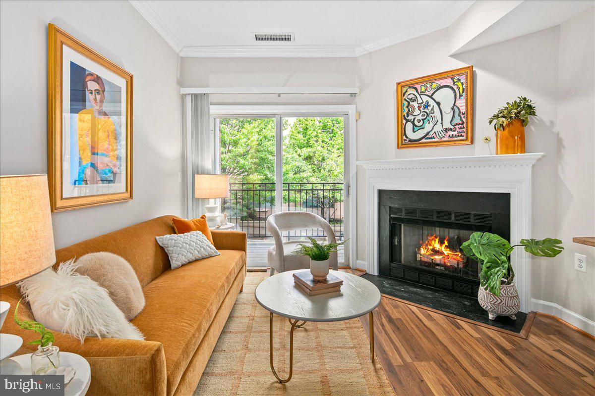 This isn't just a condo; it’s a lifestyle upgrade. Step inside and you’re greeted by an open, airy layout that feels much larger than the square footage suggests, thanks to high ceilings and a flow designed for hosting—or just spreading out after a long day. The kitchen is inviting with updated granite countertops and an open view of the rest of the home. 

The living room features a cozy gas fireplace, perfect for those nights when you want to unwind, and the oversized bedroom is a true sanctuary with enough space for a king-sized bed and a dedicated WFH setup. Best of all? You have your own private balcony, the perfect spot for a morning coffee or an evening drink while you take in the fresh air. 

The community features a clubhouse building with gym, package receiving, common room, and pool for those hot summer days. Underground assigned garage parking makes coming and going by car a breeze - and you’re two blocks from access to Rte 50, getting you anywhere you might need to go. Pet-friendly and investor friendly, there’s no catch. 

The current owner has meticulously maintained this home over many years to ensure it’s move-in ready. Updates include whole home paint (2026), dishwasher (2026), water heater (2025), Stove and microwave (2023), Bath surround (2021), Washer/dryer (2021), Refrigerator (2021), HVAC (2018).
Perhaps the best part of this home… isn’t the home. It’s the neighborhood. You are about two blocks from the Metro, and the walk there is a breeze through a dedicated pedestrian way rather than dodging traffic on the main drag. Within easy walking distance are world class coffee houses, Whole Foods, boutique fitness studios and restaurants. With a building that includes a clubhouse, gym, and pool, you’ve officially won the North Arlington real estate lottery.