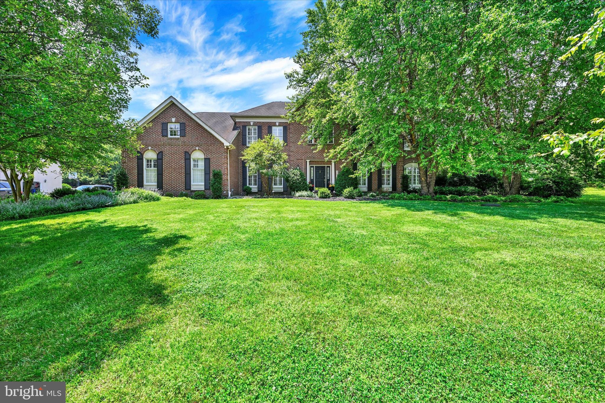 Opportunity Knocks To Own A Toll Brothers Home! You must see this well maintained one of a kind unique spacious 6 bedroom, 5 and 1/2 bath home over 6000sf  of living space that boast a luxury private in-law suite on the main level with patio doors that leads to a porch surrounded by beautiful landscaping and trees.  First step into  the magnificent freshly painted home with 9ft ceilings and plantation shutters throughout  that opens up to an elegant two-story foyer with a turned stair case that offers wide sprung decorative molding and a dramatic overlook in the front and rear of the home.  The living room features  wood floors, decorated columns, recessed lighting with plenty of natural light.  The dining room offers wood floors, a tray ceiling, chair molding, and space to host large dinners for family and guests. The updated beautiful bright kitchen includes new wood flooring, updated lighting, new quartz counter tops and a custom backsplash, a nice island, a gas cooktop,  double wall oven, stainless steel appliances including two new double stainless refrigerators a chef's choice, a butler's pantry, plenty of storage  space and  rear dual staircase. The oversized family room features a nice stone wood burning fireplace with a mantle that leads to an office or flex room.  The main level also offers an expansive mud room with custom built-in shelving, new wood floors, and a washing area with a utility sink for convenience. The upper level offers 4 spacious bedrooms  with new carpet on the floors and staircase. The upper level  primary ensuite includes two nice walk-in closets with built-in shelving,  a sitting room,  a nice private bathroom with updated lights, a vaulted ceiling, dual sinks, a jacuzzi soaking bath tub with jets and a separate shower. The lower level features the 6th bedroom, an exercise room, an expansive recreation room with a nice kitchenette ideal for entertaining, and tons of storage space with more built-in shelves.  This home has multiple heating and cooling systems. The exterior features includes a stately brick front with picturesque landscaping, an extended  driveway with an oversized side loaded garage that accommodates three vehicles. The rear of the home includes a stunning custom brick patio in a tranquil setting, ravishing landscaping,  a play set and a huge leveled lot for endless possibilities. This lovely home could be yours.  Call and Schedule your appointment before it is too late!