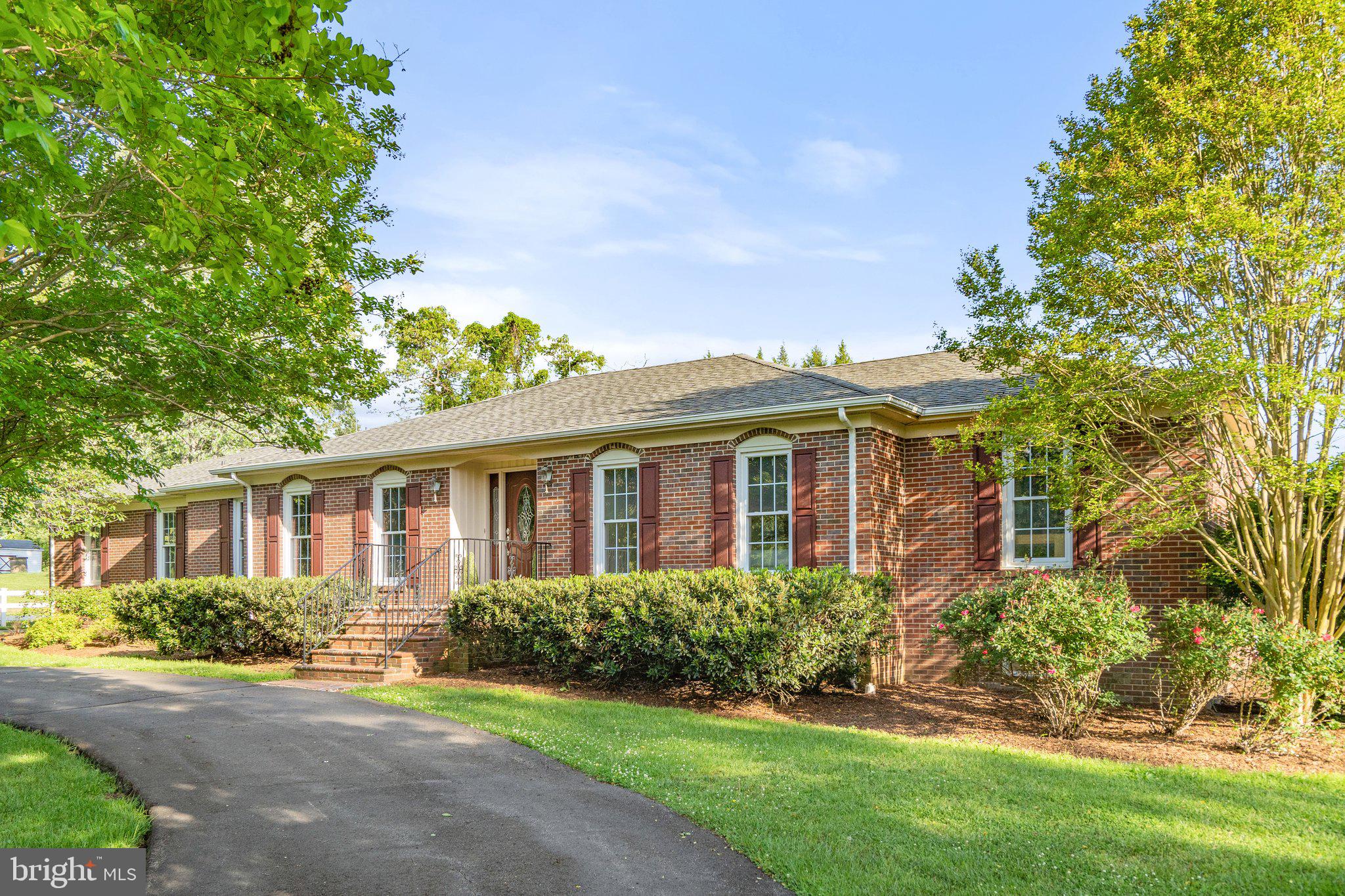 Beautiful brick rancher with 2,300 Sq Ft of main level living in Casanova! This lovely home boasts gleaming hardwood floors, 3 bedrooms & 2 full baths, a great room with built-in shelving and a 2-sided fireplace, a den and additional room for home office.  The finished lower level offers possibilities for separate living with  bedroom, full bath, kitchenette, den and private entrance.  Outside you'll find a  2-car detached garage, 5-car detached garage/workshop, 7 stall barn, indoor heated swimming pool and lovely enclosed porch, all  on 9 picturesque acres, complete with stocked pond! Bring your horses or other farm animals, set up a home business or just enjoy country living.