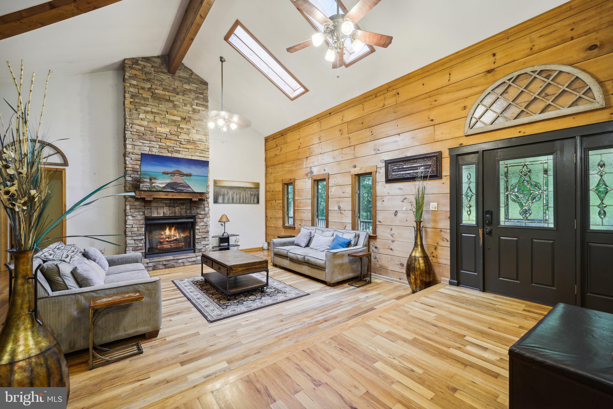 OPEN this Weekend SATURDAY JUNE 6, 2026   - 11 AM - 2 PM

Secluded 5.48 -Acre Log Estate with Guest Apartment & River Access
Tucked away among mature trees on on close to six private acres, this distinctive log estate offers a peaceful country retreat near the Port Tobacco River, combining privacy, nature, and flexible living space in a beautiful setting.

Located within convenient reach of Washington, DC, La Plata, and surrounding Southern Maryland communities, the property offers the perfect balance of accessibility and seclusion for those seeking a full-time residence or a private weekend escape from the city.

With more than 5,000 square feet of living space, the home blends rustic character with modern comfort. The main level features soaring ceilings, exposed beams, and expansive windows that bring natural light into the spacious living areas, creating a warm and inviting environment for everyday living and entertaining.

The updated kitchen includes granite countertops, stainless steel appliances, and generous space for gatherings with family and friends.

The recently renovated owner’s suite features a beautifully updated bathroom, while additional bedrooms provide flexibility for guests, family members, or work-from-home space.

The fully finished lower level adds exceptional versatility with a second kitchen, additional bedrooms, a full bath, and office space—ideal for multi-generational living, extended guest stays, or private living quarters.
Adding even more flexibility, the separate apartment above the detached garage offers its own entrance, kitchen, and living area. This space can serve as a guest suite, home office, private retreat, or potential rental opportunity.

Outdoor living is where this property truly shines. Wraparound porches, patios, a swim spa, fire pit, koi pond, and expansive deck areas overlook the surrounding woods, creating a peaceful environment perfect for entertaining or relaxing in nature.

Residents also enjoy community access to the Port Tobacco River, including a private pier and boat ramp for boating, kayaking, fishing, and outdoor recreation just minutes from the home.  Unlike traditional suburban homes, this property offers a rare opportunity to enjoy private estate-style living surrounded by nature while still remaining within reach of regional amenities.

Seller welcomes serious inquiries and will consider strong offers.
Schedule your private showing to experience the charm, tranquility, and lifestyle this unique property has to offer.