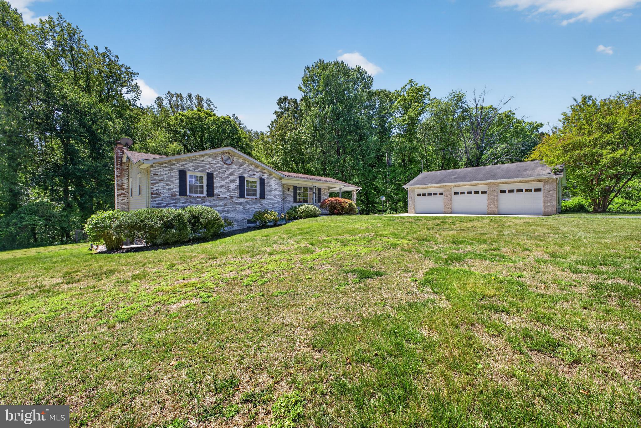 Impressive 4BR/3.5BA expanded Rancher with a detached three-car garage tucked into the landscape at the end of a cul-de-sac in the quiet neighborhood of Belle Ridge Farms.  Pull into the elongated driveway, go past the detached 3-car garage, park under the attached carport and make your way to the covered front porch of your new home. Step inside a home filled with natural light, hardwood floors, new carpet throughout, and expansive living spaces.  The main living area offers a spacious living room, a large eat-in kitchen, and an oversized family room with a wood burning stove.  The kitchen boasts ample cabinet space and room for a large dining table.  Down the hall are two sizable secondary bedrooms, a full bath, and a larger primary bedroom with a private full bath featuring a walk-in shower. The grand primary suite, located just off the family room, features a walk-in closet and a private en-suite with a double sink vanity and a walk in linen closet.  The lower level is mostly finished and offers a large oversized recreation room, a wood burning stove, laundry, a half bath, and sliding doors to the amazing yard. There's plenty of space ideal for a home office, gym, or playroom.  The sprawling yard, filled with mature trees and landscaping, offers you the opportunity to create the outdoor living space your family seeks. This move-in-ready home has been well maintained by it's original owner, and is ideal for any homeowner, located near Oak Ridge park, shopping, restaurants, and commuter routes.