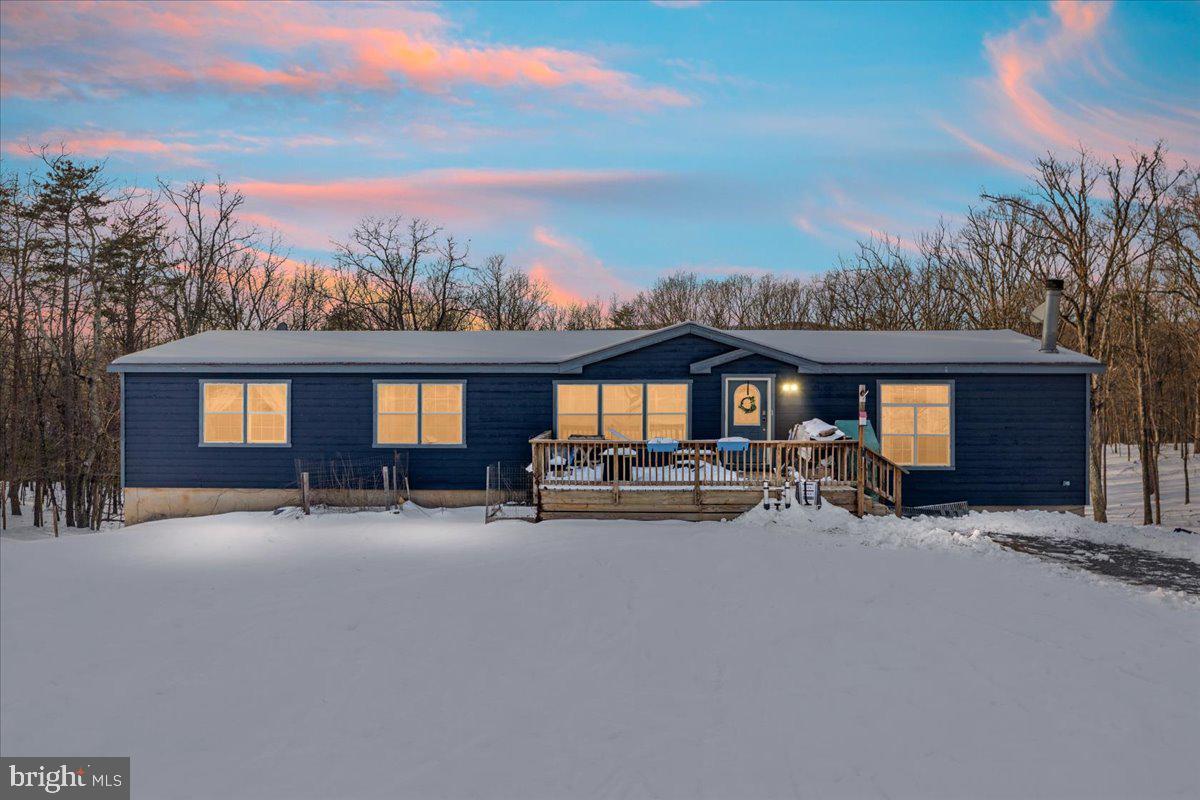 Bring the 4-wheelers, the animals, and your hunting gear — this incredible 3 bedroom, 2 bathroom rancher offers over 23 UNRESTRICTED acres complete with trails and a stream! Enjoy more than 2,000 sq ft of living space on the main level, plus a full unfinished basement of equal size with impressive 10-foot ceilings. Recent upgrades include new LVP flooring throughout the main level, an updated hallway bath, kitchen, and primary ensuite, added fresh exterior paint, and a gravel driveway. The open-concept layout features cathedral ceilings, a spacious kitchen with stainless steel appliances, black cabinetry, island seating, and pendant lighting. The family room showcases exposed beams and a stunning stone wood-burning fireplace with hearth and mantel. You’ll also find a separate breakfast area/dining room and convenient main-level laundry. The large primary suite on the main level includes a double-entry walk-in closet, dual sinks, walk-in shower, soaking tub, and skylight for natural light. Downstairs offers incredible potential with a massive rec room, built-in bar, bonus room, and tons of storage space. Additional features include surround sound throughout the main level, a one-car rear-entry garage, and a spacious front porch perfect for relaxing and taking in the peaceful surroundings. Don't miss out on this amazing property in Frederick County!