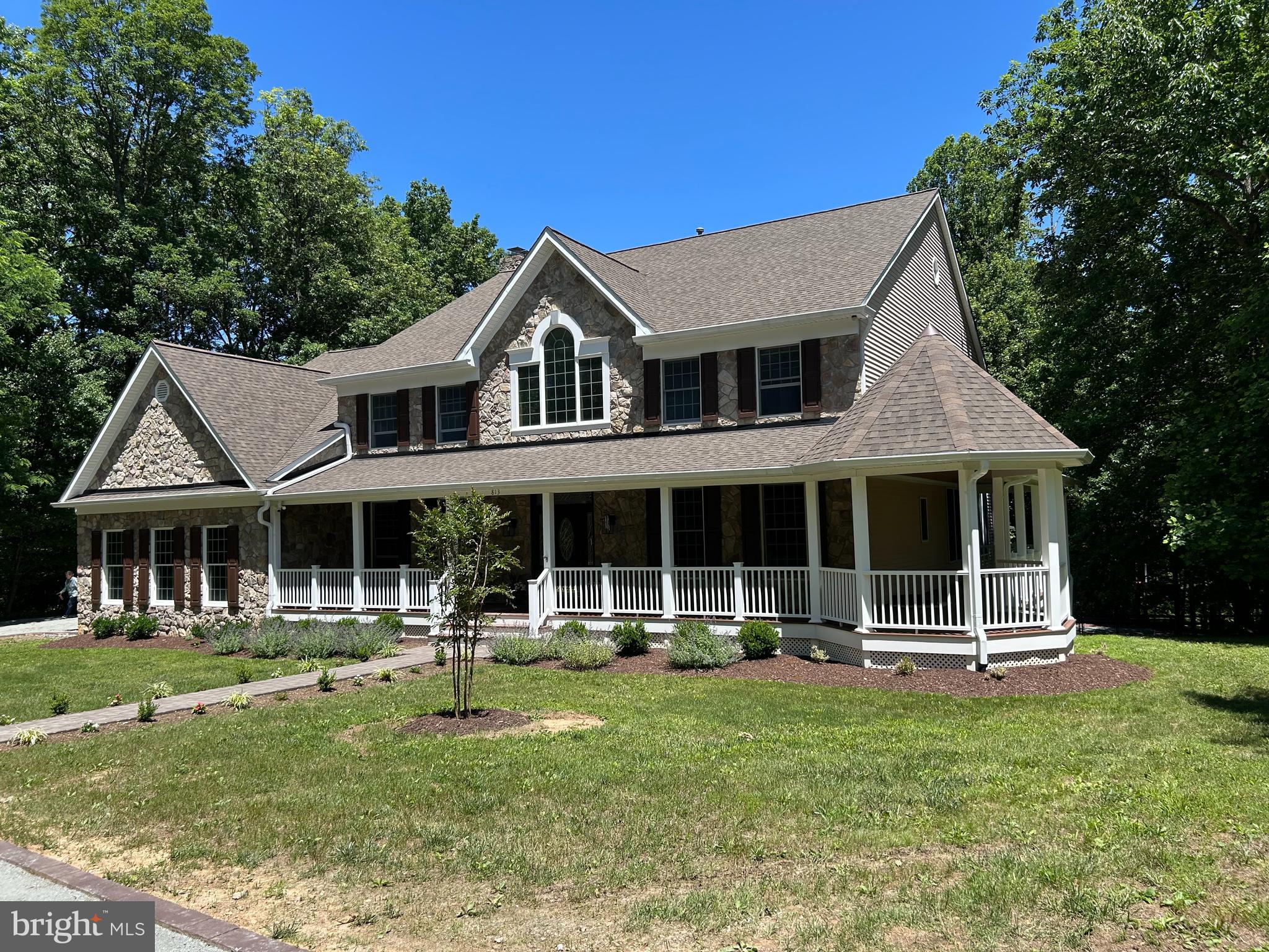 Welcome to this exceptional CUSTOM Great Falls Estate with 5 Bedrooms & 5.5 Baths with approx. 7,200+ sq. ft on 3 finished levels.  This stunning home offers privacy, a prime location, and elegant living with all the amenities that you would expect.  Nestled on a private country road, imagine driving down this private road that opens up to 3 acres of trees & fenced pasture where nature welcomes you!  Reminiscent of days gone by just relax on the wrap-around front porch or enjoy the stunning private backyard retreat that the built-in pool and sports court offer with family & friends.  You can also enjoy all the fun and entertainment from the large upper deck or lower patio.  If you are a horse lover, you will appreciate the Barn with stalls and fenced pasture or just enjoy the convenience of storage for your antique car, tools and/or yard equipment.  This home has it all and has been lovingly maintained & updated by the Original Owners.  This home greets you with an expansive foyer with a sweeping hardwood staircase & refined architectural detail throughout.  It features hardwood floors on the main level, 3 fireplaces (one gas), built in speakers for your sound system, & is freshly painted.  This gracious and stately floorplan with 9' ceilings is highly functional with a multitude of rooms creating an inviting atmosphere for both everyday living and entertaining.  This includes rooms such as a music room, study/office with custom shelving, formal dining room, family room, morning room, sunroom and mud room with 1.5 baths on the main level and pocket doors throughout.  The kitchen will easily welcome & accommodate all of your guests and family with SS appliances, 42" custom cabinetry with wine rack, stylish countertops with coordinating backsplash, 2 pantries, and a large peninsula which is great for entertaining.  The large eat-in kitchen with table space fills the room with natural light and opens to the large rear deck with a view of the pool and sports court below.  The grand family room welcomes you with an impressive, over-sized stone fireplace to enjoy on those cool nights.  You can conveniently access the large 3-car garage from the family room and/or mud room which offers plenty of storage & shelving.   The mud room, just off the kitchen, is complete with a laundry room & deep sink, full bath and a side entrance to the rear deck and below which is so convenient for use after a long day at the pool or sports court.  The upper level greets you with a spacious loft area with hard wood flooring & 4 generously sized surrounding bedrooms, all with new carpeting and 3 renovated/updated full baths.   The luxury primary suite offers a sitting room with a balcony overlooking the rear yard, 2 spacious walk-in closets and an ensuite bathroom with custom tile, large vanity with dual sinks, separate shower with frameless glass, & an oversized jetted tub for a spa-like experience!  The expansive Walk-Out Lower Level increases the living space greatly with all NEW flooring, recessed lighting, and is freshly painted throughout.  The large recreation room offers a cozy stone fireplace, media area, bar for entertaining, and a 5th bedroom with a Walk-Out to the rear lower paver patio and full bath which is great for your family, guests or an au pair!  There are also multiple bonus spaces for your fitness equipment and other hobbies.  A large work room with a workbench, storage, and shelving also increases the versatility of this lower level.  No worries, if the power goes out you have a Generac Generator to keep you comfortable.  The Roof, HVAC & HWH have all been recently replaced!!  Conveniently located just off 193 (Georgetown Pike) near the Great Falls Village Centre, convenient to Shopping, Dining and Grocery Stores.  Also, in the highly sought after Langley, Cooper & Forestville school pyramid.  Great commuter location near Rt. 7 with easy access to Tysons Corner, DC, Dulles & Reagan airports.  NO HOA....just move-in and enjoy!!