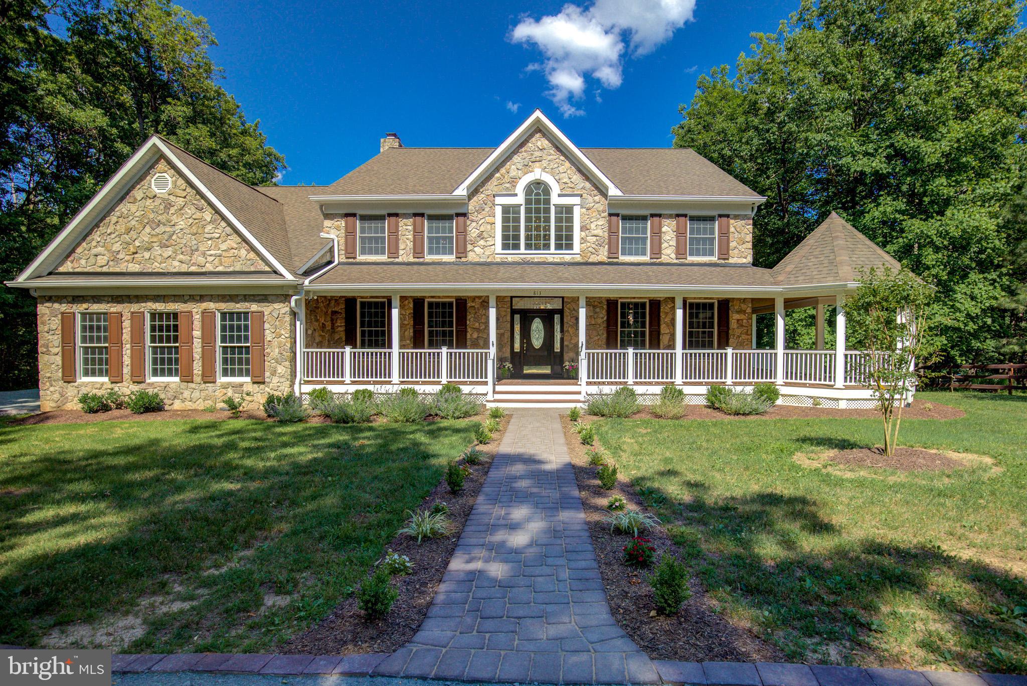 Welcome to this exceptional CUSTOM Great Falls Estate with 5 Bedrooms & 5.5 Baths with approx. 7,200+ sq. ft on 3 finished levels.  This stunning home offers privacy, a prime location, and elegant living with all the amenities that you would expect.  Nestled on a private country road, imagine driving down this private road that opens up to 3 acres of trees & fenced pasture where nature welcomes you!  Reminiscent of days gone by just relax on the wrap-around front porch or enjoy the stunning private backyard retreat that the built-in pool and sports court offer with family & friends.  You can also enjoy all the fun and entertainment from the large upper deck or lower patio.  If you are a horse lover, you will appreciate the Barn with stalls and fenced pasture or just enjoy the convenience of storage for your antique car, tools and/or yard equipment.  This home has it all and has been lovingly maintained & updated by the Original Owners.  This home greets you with an expansive foyer with a sweeping hardwood staircase & refined architectural detail throughout.  It features hardwood floors on the main level, 3 fireplaces (one gas), built in speakers for your sound system, & is freshly painted.  This gracious and stately floorplan with 9' ceilings is highly functional with a multitude of rooms creating an inviting atmosphere for both everyday living and entertaining.  This includes rooms such as a music room, study/office with custom shelving, formal dining room, family room, morning room, sunroom and mud room with 1.5 baths on the main level and pocket doors throughout.  The kitchen will easily welcome & accommodate all of your guests and family with SS appliances, 42" custom cabinetry with wine rack, stylish countertops with coordinating backsplash, 2 pantries, and a large peninsula which is great for entertaining.  The large eat-in kitchen with table space fills the room with natural light and opens to the large rear deck with a view of the pool and sports court below.  The grand family room welcomes you with an impressive, over-sized stone fireplace to enjoy on those cool nights.  You can conveniently access the large 3-car garage from the family room and/or mud room which offers plenty of storage & shelving.   The mud room, just off the kitchen, is complete with a laundry room & deep sink, full bath and a side entrance to the rear deck and below which is so convenient for use after a long day at the pool or sports court.  The upper level greets you with a spacious loft area with hard wood flooring & 4 generously sized surrounding bedrooms, all with new carpeting and 3 renovated/updated full baths.   The luxury primary suite offers a sitting room with a balcony overlooking the rear yard, 2 spacious walk-in closets and an Ensuite Bathroom with custom tile, large vanity with dual sinks, separate shower with frameless glass, & an oversized jetted tub for a spa-like experience!  The expansive Walk-Out Lower Level increases the living space greatly with all NEW flooring, recessed lighting, and is freshly painted throughout.  The large recreation room offers a cozy stone fireplace, media area, bar for entertaining, and a 5th bedroom with a Walk-Out to the rear lower paver patio and full bath which is great for your family, guests or an au pair!  There are also multiple bonus spaces for your fitness equipment and other hobbies.  A large work room with a workbench, storage, and shelving also increases the versatility of this lower level.  No worries, if the power goes out you have a Generac Generator to keep you comfortable.  The Roof, HVAC & HWH have all been recently replaced!!  Conveniently located just off 193 (Georgetown Pike) near the Great Falls Village Centre, convenient to Shopping, Dining and Grocery Stores.  Also, in the highly sought after Langley, Cooper & Forestville school pyramid.  Great commuter location near Rt. 7 with easy access to Tysons Corner, DC, Dulles & Reagan airports.  NO HOA....just move-in and enjoy!!