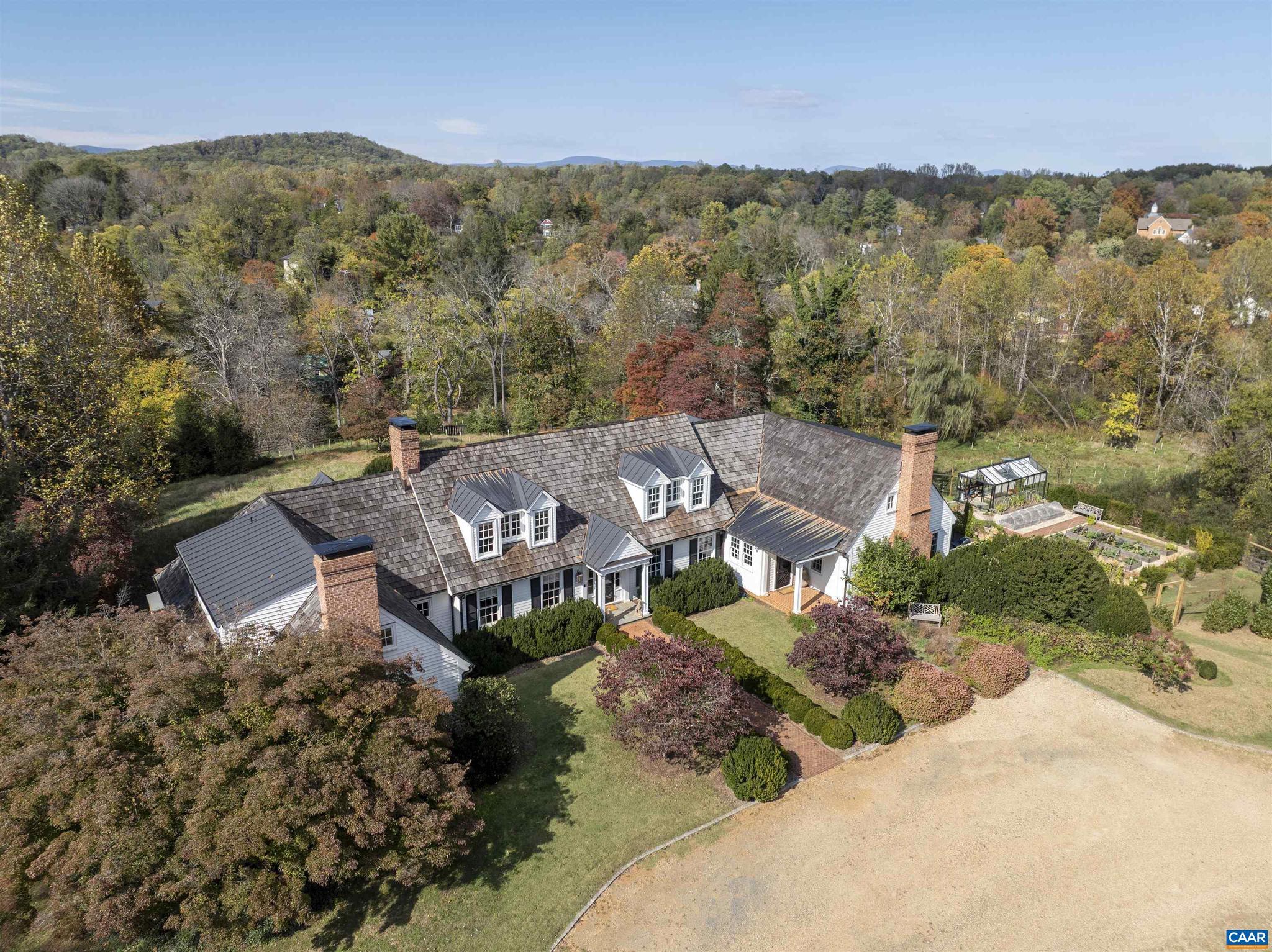 Fairhill - A remarkable property of significant architectural quality offering a timeless blend of English country design & modern livability on 6.67 private acres, walkable to village of Ivy, and less than 5 miles west of Charlottesville. The main residence (just over 7,000 fin.sq.ft) features exquisite living spaces & exceptional craftsmanship throughout, including a stunning library with custom bookshelves & wood-burning fireplace. The fully outfitted chef?s kitchen with marble counters, stainless appliances & two walk-in pantries invites cooking, entertaining & true garden-to-table living. French doors & multiple terraces create seamless indoor-outdoor flow with views of terraced lawns & Little Ivy Creek. A professionally designed culinary garden with greenhouse & irrigated raised beds brings a purposeful connection between the kitchen & the landscape. The main-level primary suite enjoys its own private patio connecting to the grounds. Four additional bedrooms offer plenty of space for family. There is an impressive 2-bedroom guest cottage with full kitchen and wood-burning fireplace that provides luxurious accommodations for guests or extended stays. A rare opportunity in one of Albemarle County?s most desirable settings.,Marble Counter,White Cabinets,Wood Cabinets,Wood Counter,Fireplace in Basement,Fireplace in Family Room,Fireplace in Living Room