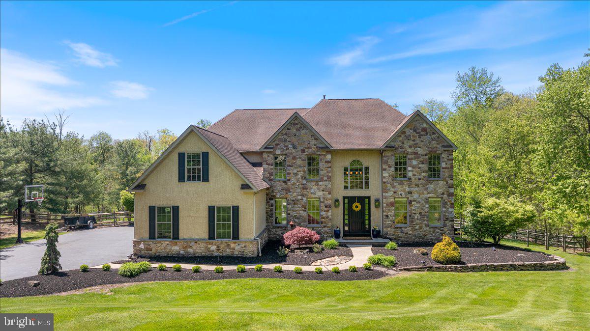Welcome to 104 Pickwick Drive—an extraordinary custom estate gracefully set on 2.86 acres in the heart of Doylestown. Privately positioned at the end of a long, winding driveway, this distinguished residence offers a rare combination of sophistication and timeless design. A grand 8-foot entry door opens to a dramatic two-story foyer with a sweeping center staircase, flanked by a formal dining room adorned with crown molding and a refined sitting room. A private home office with double doors provides a quiet, sunlit workspace overlooking the serene rear grounds. At the center of the home, a breathtaking two-story family room showcases a striking stone fireplace and a wall of windows that bathe the space in natural light while framing picturesque views of the property. The adjacent kitchen is thoughtfully designed for both everyday living and effortless entertaining, featuring a spacious island, abundant cabinetry, and direct access to the expansive deck—perfect for seamless indoor-outdoor gatherings. The main level is completed by a well-appointed laundry room, a powder room, and access to the three-car garage with freshly finished epoxy floors and custom slat walls. Upstairs, a thoughtfully designed layout with dual staircases leads to four generously sized bedrooms, along with three full bathrooms. The luxurious primary suite is a true sanctuary, featuring multiple walk-in closets, a versatile bonus room ideal for a sitting area, nursery, or private office, and a beautifully updated spa-inspired bath with dual vanities, soaking tub, stall shower, and heated floors—all overlooking the scenic backyard. The finished walk-out lower level offers exceptional flexibility, complete with a full bathroom, kitchen area with cherry cabinetry, corian counters, multiple entertaining and recreation areas, and abundant storage—perfect for extended living or hosting guests! Step outside to your own resort-style retreat. A newer elevated deck transitions to an expansive paver patio and a stunning in-ground pool, all surrounded by lush, mature landscaping and a fully fenced backyard—offering exceptional privacy and space to entertain, unwind, or simply enjoy the tranquility of the setting. An outdoor speaker system enhances the experience, creating the perfect ambiance for gatherings or quiet evenings at home. Offering a rare blend of refined living, modern comfort, and natural beauty, this exceptional 4-bedroom, 4.5-bath home is located within the highly acclaimed Central Bucks School District and just minutes from the charming shops, dining, and cultural attractions of Doylestown. This is a rare opportunity to own a truly special Bucks County estate.