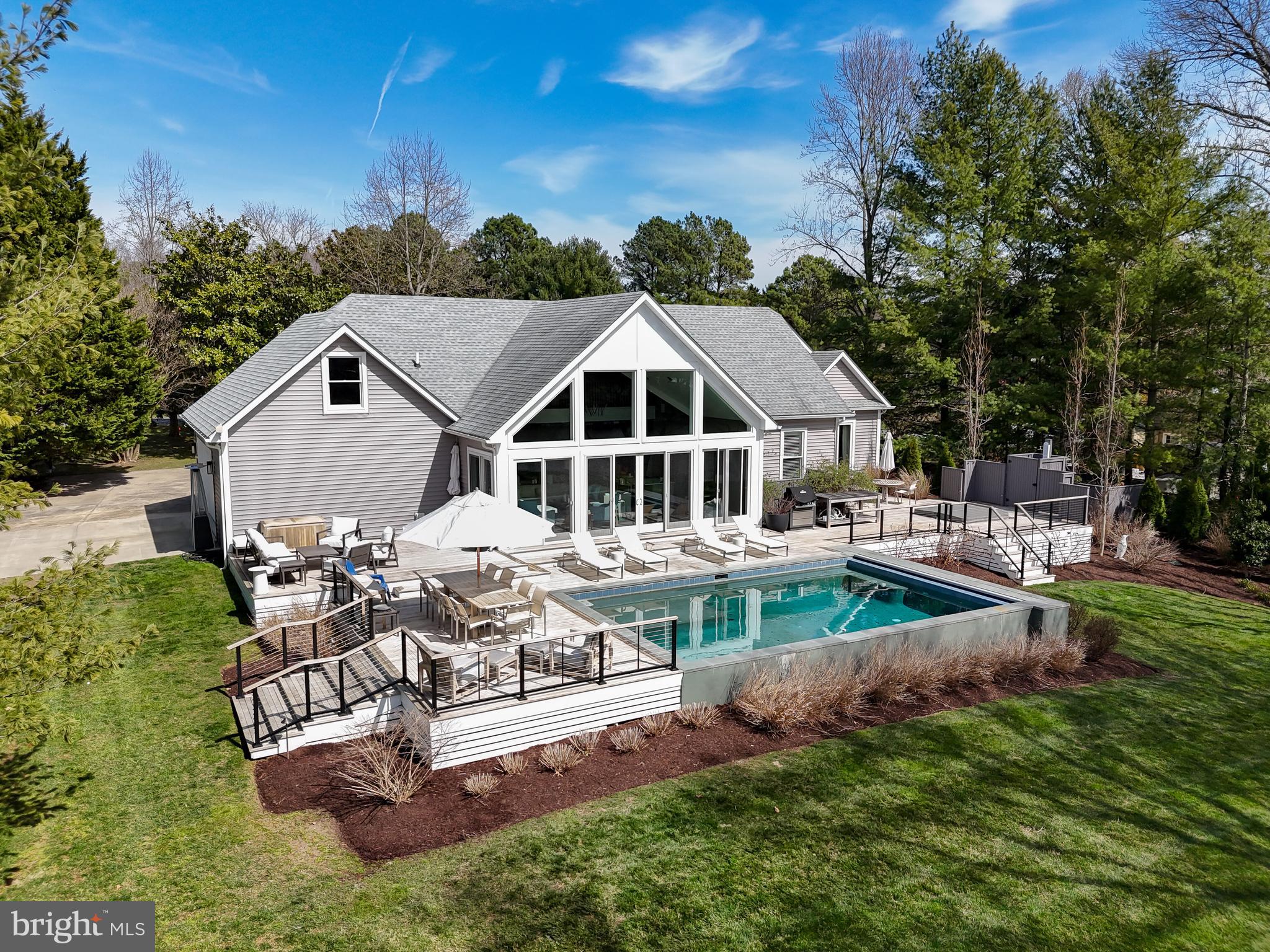 Presenting a stunning new Talbot County waterfront listing located in the sought-after community of Northbend off St. Michaels Road.  Overlooking picturesque Chapel Cove on the Miles River, this lovely 2800+sf 1.5 story residence offers 3 bedrooms and 2.5 baths in a premium location just minutes from downtown Easton and historic St. Michaels.  Built 8 years ago, this home includes recent high-quality upgrades including a 1000sf+ Ipe rear deck overlooking the Cove complete with cable deck railing, a heated gunite pool with Baja shelf and automatic cover, a 6-person hot tub and a private outdoor shower.  Inside, an open concept floorplan with a wall of waterside windows provides breathtaking SW water views.  Additional highlights include a gourmet kitchen, second private kitchen/butler's pantry and first floor laundry as well as a second-floor family room/loft with breathtaking water views.  A 2-car garage, geothermal HVAC, encapsulated crawl space, professional landscaping, exterior irrigation and lighting are additional features of this luxurious property.  Public sewer is under construction in Northbend which gives owner flexibility for future expansion including the possibility of an additional 2nd floor bedroom suite (or other use) in existing unfinished space over garage.  Sketches are available for 2nd floor suite as well as architectural drawings for a waterside screened porch.  The existing backyard deck complex and backyard landscaping plans were created by local Landscape  Designer Jan Kirsh.  All designer furnishings, art, and household items (with the exception of a few personal items) are available and negotiable outside the real property transaction.  Bailey Marine Contractor's assessment of pier and shoreline available including estimates for pier replacement and future (5-7 years) potential shoreline work.  All as-is and factored into pricing.  Please note that tax record square footage includes 2nd floor unfinished space, actual current finished space is 2800fsf+/-.
