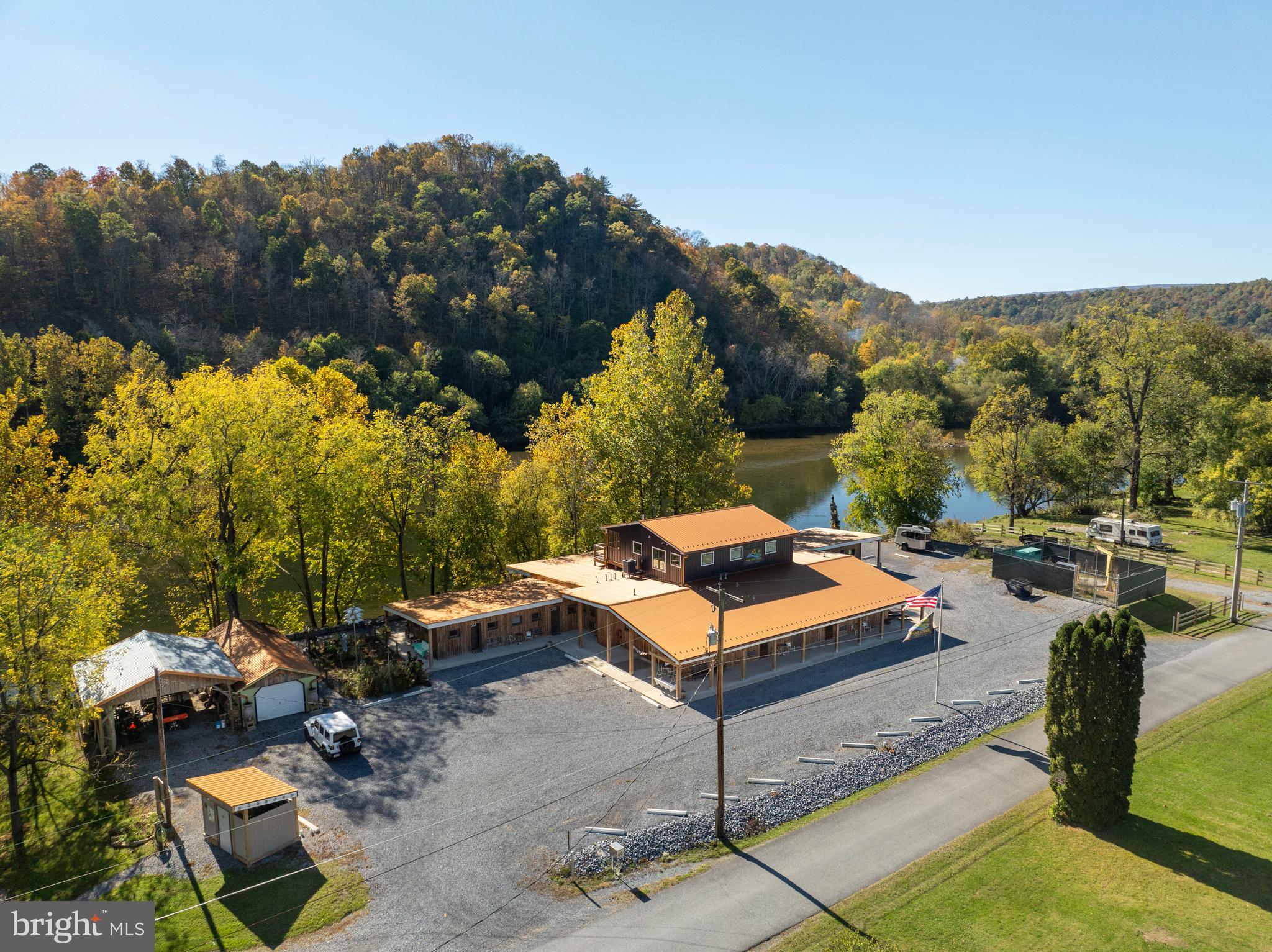 Originally built in 1954 and fully revitalized in 2022 after two decades of vacancy, this popular resort is a serene escape nestled along 650 feet of private Juniata River frontage. Now considered new construction, over 90% of the resort has been rebuilt to modern code, with the addition of a second story Host’s Loft - ideal for a private residence or luxury rental, featuring a full sprinkler system. The boutique campground near the river is perfect for family getaways, while the adult-focused Guest Lodge provides abundant amenities and panoramic views.

The Lodge offers 12 well-appointed guest rooms: five with two queen beds, one ADA-compliant room with Twin XL beds, and six with king beds. Seven bathrooms have been completely renovated, while five preserve charming vintage tub/shower combos favored by returning guests. Six spacious, shaded riverfront camp lots provide 30A and 110A electric, fire rings, picnic tables, and access to a rustic, open-air shower house.

Seasonally open from May through September, the resort draws a growing guest base each year, attracted by its tranquil atmosphere. Amenities include riverside decks and steps, two fire pits, fishing pier, kayak/swimming launch, two shower houses, and a communal outdoor kitchen stocked with tableware and cooking essentials. Filtered water refill stations and 24/7 coffee and tea service enhance guest comfort.

Guests enjoy outstanding birdwatching, stargazing, and smallmouth bass fishing, along with popular kayak and tube floats. The resort welcomes visitors from major metro areas including Philadelphia, Pittsburgh, Baltimore, and Washington, D.C.

Opportunities for expansion include activating a hotel liquor license, adding restaurant service, introducing alternative lodging (yurts, treehouses, etc.), or developing event spaces for weddings and reunions. There's also potential for a coffee shop or bistro, and ample space for a pool or hot tub.

Included in the sale: a loyal guestbook, active Airbnb listing, integrated website with booking software, Facebook page, professional media (photos, videos, drone footage), and fully furnished, guest-ready rooms with linens, robes, toiletries, and dining sets.

Located adjacent to American Legion Country Club Golf Course and near local attractions like Raystown Lake, Amish Country, and East Broad Top Railroad, this resort is a turn-key opportunity with proven growth and unique appeal. Make your wildest dreams a reality; schedule a private showing today!