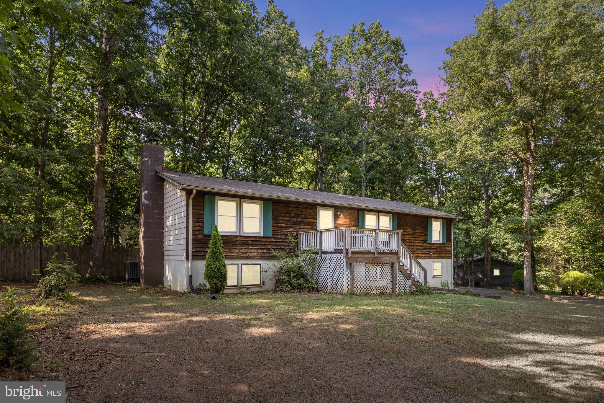 Welcome to 12400 Toll House Rd!  This 4 Bedroom 2 full bath home is situated perfectly on a .64 acre corner lot, back from the road. Both the front and the back yard are large and flat. The back yard is fully fenced!  Inside you will find over 2400 sq/ft and many upgrades including HVAC system both inside and out with variable speed air handler replaced in 2019, wood siding sealed 2021, outside of house and garage doors painted in 2021, new outdoor lights installed  2021, shutters 2021, attic fan 2020, water heater 2023,  new wood  stove and improved chimney in 2022. Much of the house has been painted and all carpets replaced in 2026!  Outside, the deck features multiple levels and offers plenty of room for entertaining.  The spacious yard has mature trees as well as a firepit. This home is a part of the Lake Wilderness community which includes tennis courts, basketball courts, volleyball, beach area, an outdoor pool, playground and even a campground.