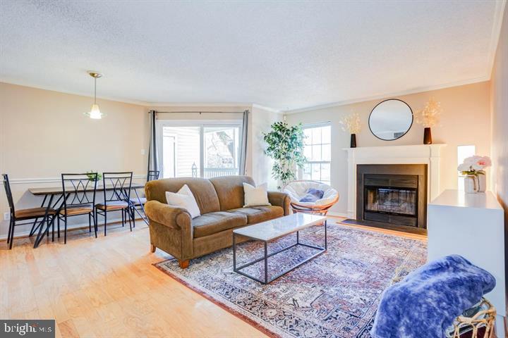 Beautiful & Bright 2BR/2BA condo in the heart of Tyson's Corner! Minutes from metro stations, Toll Road, I495, shopping galore and restaurants! This spacious condo features hardwood flooring, a warm fireplace and a private covered balcony as well as a full size washer & dryer. The updated kitchen boasts granite counter tops, breakfast bar & pantry! The open concept floor plan allows you to configure the space to your needs with an optimal dining area and living room. The primary suite features a walk-in closet and a private ensuite bathroom updated with ceramic tile flooring, a shower/tub combo with ceramic tile surround and a single sink vanity. The secondary bedroom also features a walk-in closet, a large window for natural light as well as hallway access to the secondary full bathroom. This unit also comes with 1 assigned parking space and 1 guest pass. HVAC has been updated and all windows and sliding glass door have been replaced. Don't miss out on this one....location is amazing! Condo will be painted.