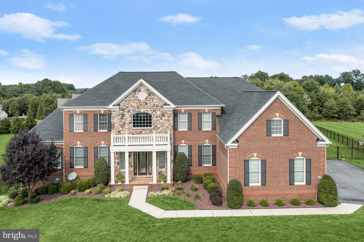 Exquisite, custom Toll Brothers single-family residence set on 0.95 acres of beautifully landscaped grounds. Includes every quality upgrade imaginable. Impeccably maintained by the original owners. Perfect for the discerning family seeking luxury, space, and convenience. From the stately curb appeal to the portico-covered front entry, this 5-bedroom, 5.5-bathroom home exudes elegance. Step into the grand two-story foyer and be captivated by the custom marble flooring, crown molding, chair railing, wainscoting, dual stairs with iron stair balusters, and stunning Romeo and Juliet balconies. Entertain guests in the formal living and dining rooms, adorned with intricate molding, lighting, and tray ceilings. Unwind in the spacious sunroom with a soaring vaulted ceiling or cozy up in the two-story family room featuring a coffered ceiling, stone-accented gas fireplace, and beautiful hardwood flooring. The chef's kitchen boasts professional-grade appliances, a six-burner gas range, display cabinetry, a tile backsplash, a walk-in pantry, a butler's pantry, a casual dining area, a breakfast room, and deck access. A library or home office adds convenience to this magnificent home. Retreat up the back stairs to the sprawling primary suite complimented with a three-sided fireplace, sitting room, and walk-in closet. Indulge in the luxury primary bath featuring a Jacuzzi, separate vanities, an oversized glass-enclosed shower, and an additional very large walk-in closet. Three en suite bedrooms offer ceiling fans and walk-in closets, with two bedrooms featuring Romeo and Juliet balconies. The lower level provides a sizable fifth bedroom, recreation room, game room, family room, exercise room, and a full bath, so much finished space! Outside, a large deck overlooks a level, landscaped fenced yard with a scenic view. Enjoy nearby amenities including Cattail Creek Country Club. With parking for 13 vehicles, this exceptional property awaits its next proud owners.