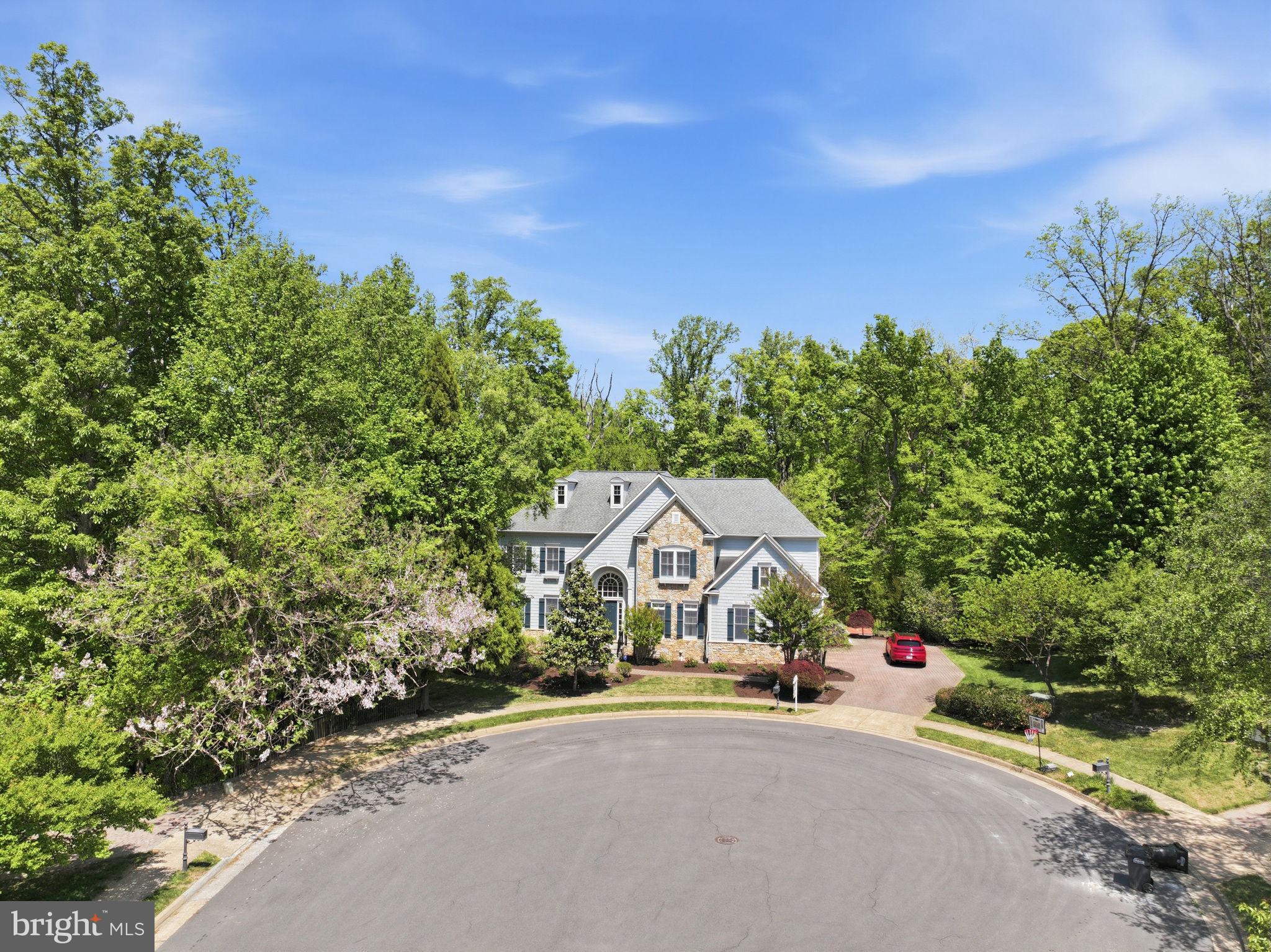 Architectural Grandeur Meets Modern Luxury in Vienna
Experience the pinnacle of suburban elegance in this stunning Sekas-built custom residence. Commandingly situated on a premier .31-acre cul-de-sac lot that backs to a serene wooded perimeter, this rare 4-level model is one of the largest in the community—boasting approximately 7,000 total square feet, including 5,000 square feet of light-filled above-grade living space.

Sophisticated Interiors 
The grand two-story (20’) foyer makes a striking first impression with its dramatic curved staircase and gleaming newly refinished hardwoods. Designed for both high-end entertaining and effortless daily living, the expansive open floor plan flows seamlessly into a gourmet chef’s kitchen with build in refrigerator and customized hardwood cabinet. A sun-drenched family room anchored by one of three cozy fireplaces. An integrated whole-house sound system allows your favorite soundtrack to follow you into every room, including the private master suites.

Unmatched Bedroom Retreats
The upper levels offer unparalleled versatility. The primary suite serves as a true sanctuary, featuring a lavish sitting room, a massive walk-in closet, and a spa-inspired bath with a dedicated makeup vanity. A secondary junior suite ensures morning harmony, while two additional bedrooms share a well-appointed Jack-and-Jill bath with double vanities. For ultimate privacy, the top-floor loft—complete with a full bath, large closet, and panoramic views—provides the perfect "escape" for a home office or guest retreat.

Entertainment & Wellness 
The fully finished walk-out lower level is a destination of its own. Host movie nights in the dedicated home theater, or entertain guests at the custom wet bar. The dedicated exercise room and adjacent full bath make morning fitness routines a breeze.

Turn-Key
Excellence Move in with total peace of mind including both HVAC units replaced (2023) and a fresh, designer paint palette throughout the interior and exterior. Outdoor Oasis & Prime Location. Step outside to your private retreat, featuring a custom deck and paver patio overlooking mature trees and lush landscaping.  Seller has built a customized Koi fish pond. It has breaded many Koi- Grand Champions over the years. However, the backyard’s generous proportions and layout provide a prime opportunity to easily refinish the pond area into a custom swimming pool if desired. Located within the prestigious Langley High School pyramid, you are just minutes from Tysons Corner, Wolf Trap, and the Silver Line Metro. This is the perfect blend of secluded luxury and urban convenience.