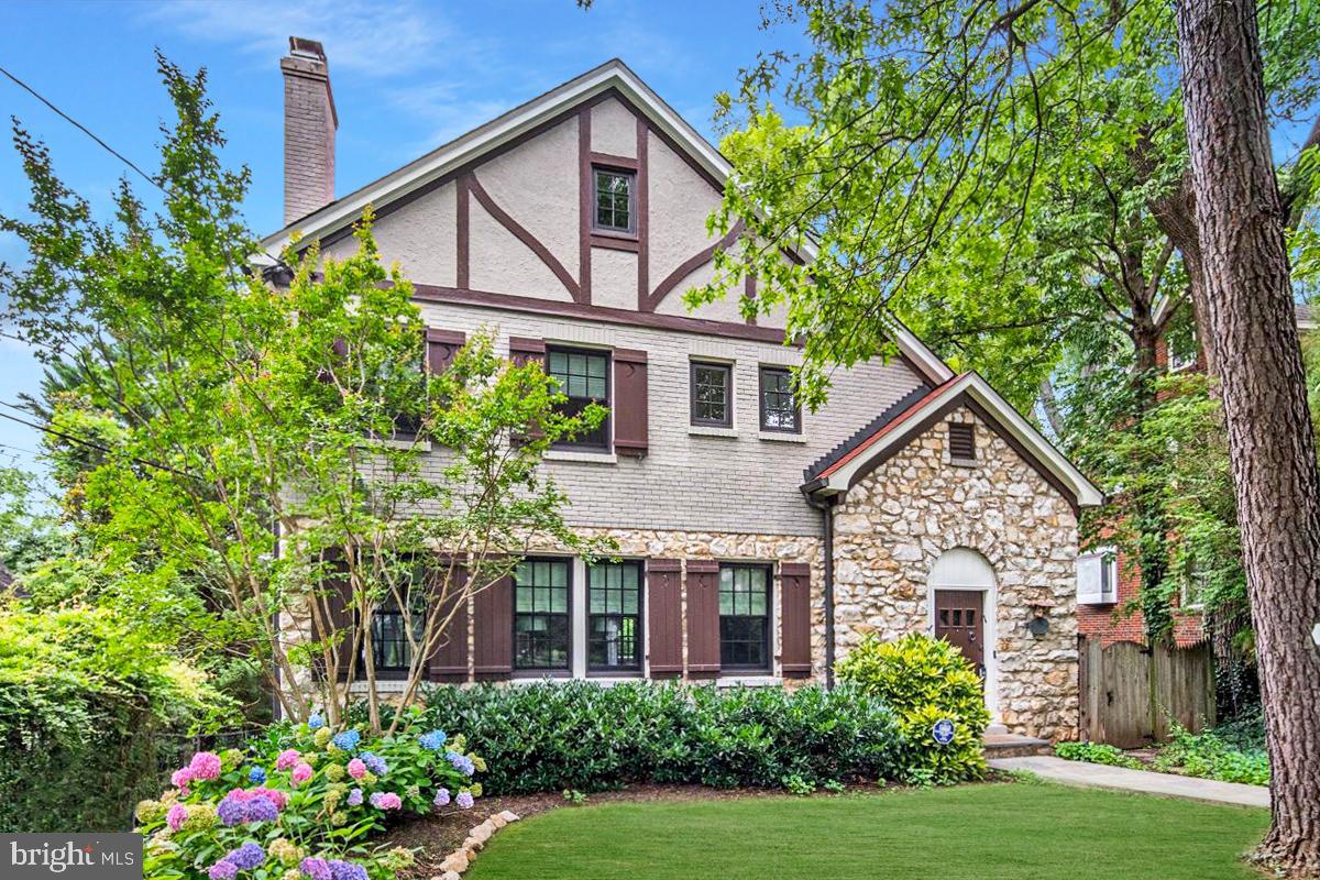 Welcome to 4619 Langdrum Lane, a beautifully maintained residence in Chevy Chase West, just over a mile from both Bethesda and Friendship Heights Metros. Enjoy close proximity to Norwood Park, the Capital Crescent Trail, and Somerset Elementary. This four-level home offers classic charm with thoughtful updates and abundant natural light.

The main level features a renovated kitchen with island seating and open flow into the dining room, a spacious living room with fireplace, and a sunroom framed by elegant stone archways. Upstairs includes a serene primary suite with ensuite bath and multiple closets, plus two additional bedrooms and a hall bath. A fireplace adds charm to one of the bedrooms.

The top level offers a private retreat with bedroom, sitting area, walk-in closet, half bath, and storage. The walk-out lower level includes a large family room, home gym, laundry, half bath, and full daylight exposure.
Outside, a stone patio and landscaped backyard provide a peaceful setting. The redone driveway offers off-street parking, completing this rare offering in a highly desirable location.

All measurements are approximate. Property details and square footage should be independently verified.
