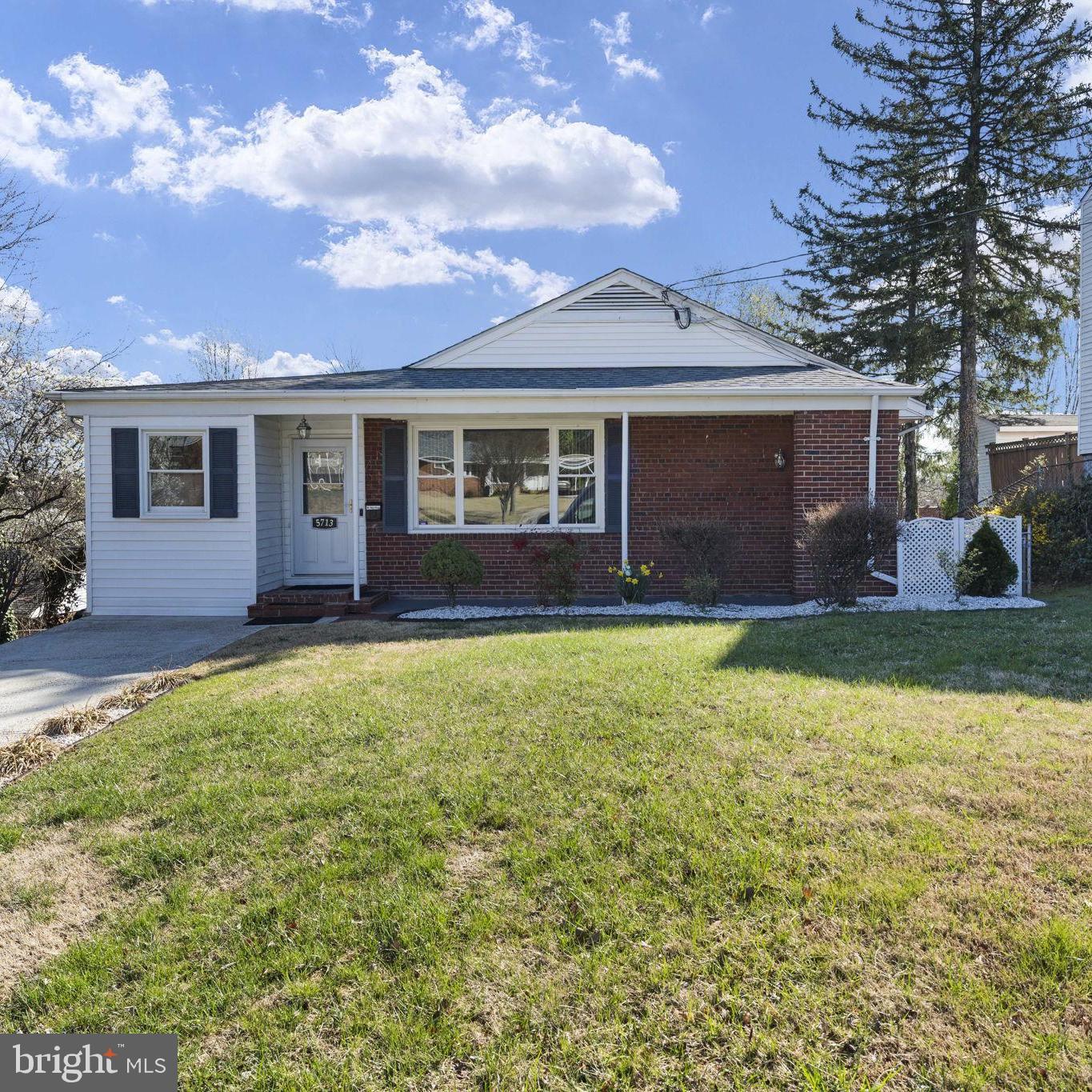 Beautiful maintained rambler with brick stoop and covered front walkway. Enter into the bonus living space with exposed brick wall, hardwood floors and sliding glass doors to the expansive deck (2020) with elevated views. This beautifully renovated and upgraded brick rambler has designer features and custom touches throughout. With a brand-new roof (2025) and major renovation (2018) opening the floorplan and adding living space. Center island kitchen with built-in microwave, granite countertops and barstool seating (2018). Stunning mosaic tile backsplash, vented range hood and updated appliances create a gourmet experience.  The bright and elegant kitchen opens to the spacious family and dining room with hardwood floors and updated light fixtures. Just off the kitchen, a hallway leads to the primary bedroom suite, which consists of two rooms that could easily become 2 separate bedrooms with the addition of a hallway door (estimate on hand). Custom sliding closet doors and designer lighting add elegance and verve. A third room, with hardwood flooring and new light fixture, and the beautifully renovated full bathroom (2018) complete the main level living. Polished porcelain and waterfall mosaic tiles with high-end shower fixtures and new lighting and mirror (2025). Dual laundry areas with upper level washer & Dryer en suite to the kitchen. 
Downstairs, the lower level is open and spacious offering 1,000 additional sq feet for you to create whatever your heart desires.  Lots of natural lighting and 2nd washer & dryer and separate utility sink. With a newly finished 2nd full bathroom, all new fixtures and lighting, gorgeous custom flooring and wall tiles.  Lower level electrical and plumbing added in 2018. French drain and sump pump 2019.
Great curb appeal and the gently sloping yard is fenced and private with a large and secure garden shed on a concrete foundation. With a higher elevated landscape, this beautiful property peers out above the rooftops and tree lines feeling spacious and private. The custom deck railings (2024) carry the symmetry of the house outdoors and the freshly painted deck (2025) and elegant shallow riser, long tread staircase is easy and comfortable for pets and people.  Windows replaced throughout, Water heater 2021, HVAC 2014.
Centrally located, this home offers quick access to all major routes and is just minutes from shopping, eateries, and all conveniences. This superbly maintained home is a rare opportunity—don’t miss this one!
