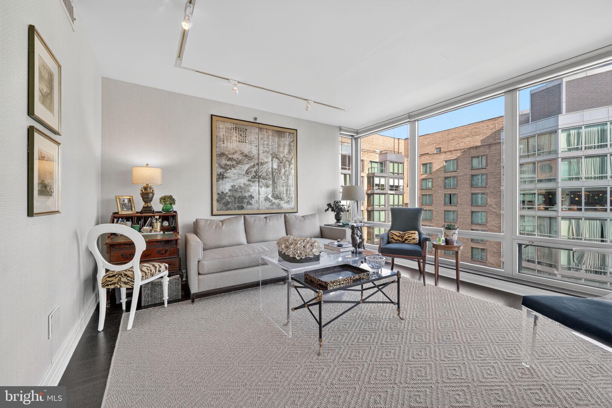 Welcome to 1155 23rd St NW Penthouse 1F (PH1F). This exceptional residence embodies sophistication and style, with bespoke interiors which are both tranquil and timeless. The entry hall opens to a spacious living and dining room featuring floor to ceiling windows with custom shades which garner beautiful sun-light throughout the day and exceptional views of the Ritz-Carlton courtyard. A gourmet kitchen offers top-of-the-line Viking & Sub-Zero appliances and Poggenpohl cabinetry paired with new Silestone countertops that will satisfy the most discerning home chef. The primary suite features a spa-like bath, black-out shades, and custom built-ins throughout. The entire unit has been freshly painted and new custom cork flooring added throughout enhances this unit's appeal. One reserved parking space completes this exceptional offering. Unquestionably, this home provides a unique opportunity for a turnkey residence of the highest standards. Enjoy all the white glove services of the legendary Ritz-Carlton, including 24-hour concierge, doormen, porters, valet parking, security, on-site storage facility, room service, housekeeping and more. The West End location provides an abundance of conveniences with numerous top restaurants, health clubs, grocery stores and is within easy distance to Georgetown and the Kennedy Center.