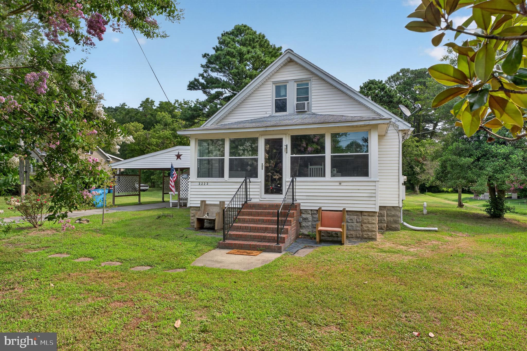 Charming 3 bedroom 2 bath bungalow style home located outside the city limits of Crisfield. Home features a large enclosed front porch perfect for enjoying the serene nature of the Eastern Shore. Outside the carport and one car garage provide plenty of storage space for all of your fishing poles, crab pots, and a golf cart---essentials for country living along the Chesapeake Bay. Jenkins Creek public boat ramp is only a few minutes' drive and within an hour you can be to Chincoteague or Salisbury.
