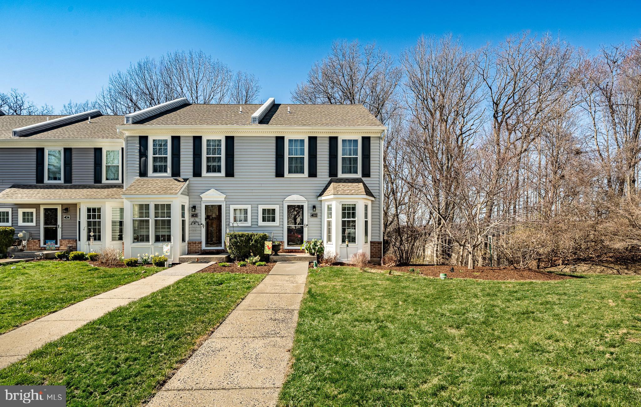 Welcome to 402 Hartford Sq., an exceptional end-unit townhome nestled in the highly sought-after Exton Station community. From the moment you step inside, you're greeted by gleaming hardwood floors, a neutral color palette, and an abundance of natural light that fills every corner of the first floor.  
The spacious, open-concept layout is centered around a cozy fireplace, flanked by picture windows and a rear door leading to the expansive deck, perfect for outdoor entertaining or simply unwinding while overlooking the serene wooded surroundings. A dedicated dining space sits conveniently near the kitchen entryway, creating the perfect flow for hosting. The beautifully updated kitchen boasts white cabinetry, neutral granite countertops, a stylish tile backsplash, and a peninsula with seating that opens into a sunlit eat-in area, complete with a bay window and an elegant chandelier. A powder room completes the main level.  Upstairs, the primary suite is a true retreat, featuring two closets, a ceiling fan with overhead lighting, and a spacious en-suite bathroom with a modern vanity. Down the hall, you'll find another generously sized bedroom and a centrally located hall bath. The third level offers a versatile loft space, perfect as a third bedroom, office, or bonus room.  The fully finished walk-out basement adds incredible living space with designated areas for entertainment, relaxation, and a separate laundry room. Step outside to enjoy the private wooded backyard, offering a peaceful escape right at your doorstep.  Living in Exton Station means enjoying an array of community amenities, including a clubhouse, in-ground pool, playgrounds, tennis courts, and more. Plus, the PRIME location provides easy access to major transportation routes and the vibrant dining, boutique shopping, and charm of West Chester Boro. Don’t miss the opportunity to make this incredible home yours—schedule your showing today!