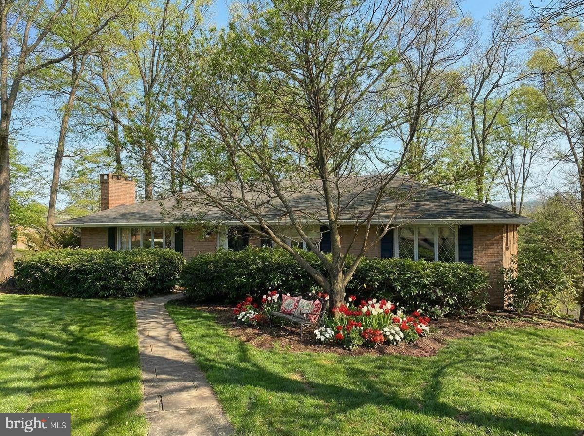 Classic one-story, brick, ranch style home on a generous parcel — conveying with additional lots — offering timeless charm and privacy. This lovingly maintained home features 4 bedrooms, 3 baths, and two inviting brick wood-burning fireplaces. Enjoy an eat-in kitchen, spacious first-floor rooms with gleaming hardwood floors, and a convenient basement two-car garage. Expansive patio doors open from the dining room and lower-level entertainment room, creating seamless indoor/outdoor flow for gatherings and relaxation. Situated with easy access to Interstate 68, the University, and all modern amenities, this property presents rare flexibility with extra land and plenty of character. You will not want to miss this one. Call Today to schedule a Tour!!!

*** Some images are AI-generated/virtually staged for illustration purposes only. Please visit and tour the property in person to verify actual condition and features.