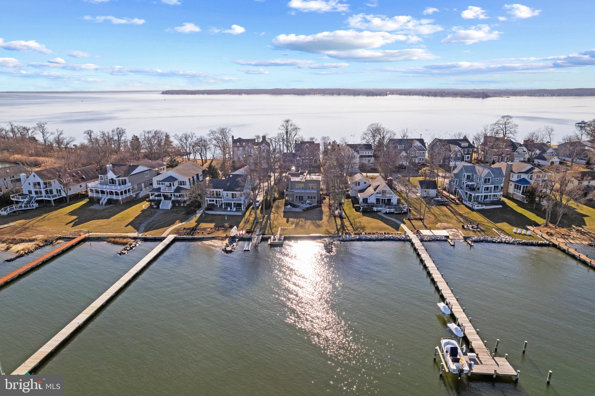 A contemporary jewel box on Fishing Creek overlooking the Chesapeake Bay! Every detail throughout the home was meticulously thought out and beautifully executed to create a gem of a home that takes advantage of the endless views. The interior gleams with curated, modern finishes with stunning features including 2 story living room with tons of natural light, wide staircase and coveted rooftop terrace. As you arrive at the property, take in the tranquility of being nestled between the South River and Fishing Creek in the wonderful Oakwood community on the Thomas Point peninsula.  Conveniently located just steps from the entrance to Thomas Point park allows you to enjoy acres of nature trails, picnic areas and pavilion right out your door. The contemporary architecture, lush landscaping and stone walkway welcome you into the home. The warm wood floors, high ceilings, natural sunlight and open floor plan greet you with a sense of serenity.  The home features an amazing gourmet Kitchen with granite countertops and island. The visually pleasing design coupled with the high end appliances are sure to please everyone. The only view more inspiring than the kitchen is the endless water views across Fishing Creek out to the Chesapeake Bay that can be enjoyed from almost every room in the house. Cozy up around the fireplace in the living room on a chilly winter evening or open the sliding glass door on a warm summer night to let in the cool breezes from the water. The main level office with adjacent full bath can easily house overnight guests and the 2 bedrooms on the upper level with shared full bath makes this property perfect for year round residents or weekend getaways. Supplementing the interior is over 1,000 sqft of exterior living space including the deck, patio and amazing rooftop terrace. Enjoy the outdoors by throwing a crab feast on the paver stone patio and the rear deck while soaking up the sun, watching the boating activity on the Bay and around the Thomas Point lighthouse in the distance.  Host amazing gathering on the roof top terrace and gaze at the stars and the twinkling lights across the Bay late into the night. Enjoy the waterfront lifestyle and feel like you are on vacation every day! Welcome Home!