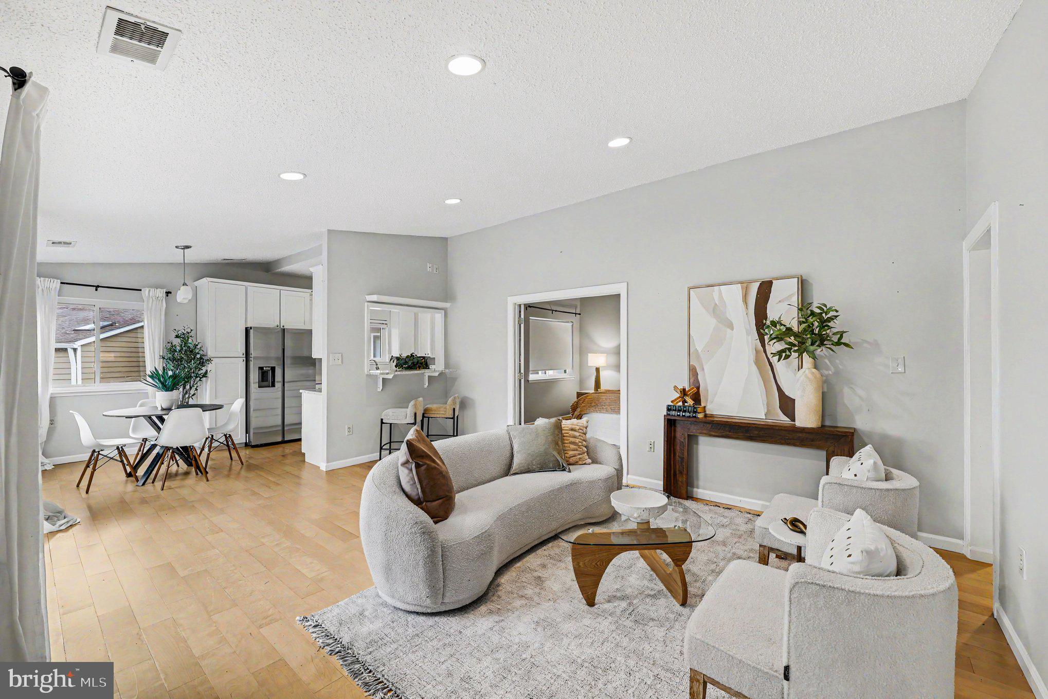 Bright, beautifully updated penthouse-style unit flooded with natural light and hardwood floors throughout. The open floor plan showcases high ceilings and modern finishes for a fresh, welcoming feel. Kitchen features 42" white shaker cabinets, granite counters and stainless steel appliances. Spacious primary suite includes a large walk-in closet and attached bath. Guest bedroom has easy access to the second full bath. Updated laundry area with front-load washer and dryer plus custom linen storage.

Prime South Reston location minutes to Lake Audubon, Lake Thoreau, South Lakes Village Center, Wiehle Metro, JW Marriott, restaurants and shopping. Enjoy Reston’s extensive outdoor amenities—walking trails, lake access, pools and tennis—perfect for morning strolls or paddleboarding. Villaridge community offers serene, convenient living with nature at your doorstep.