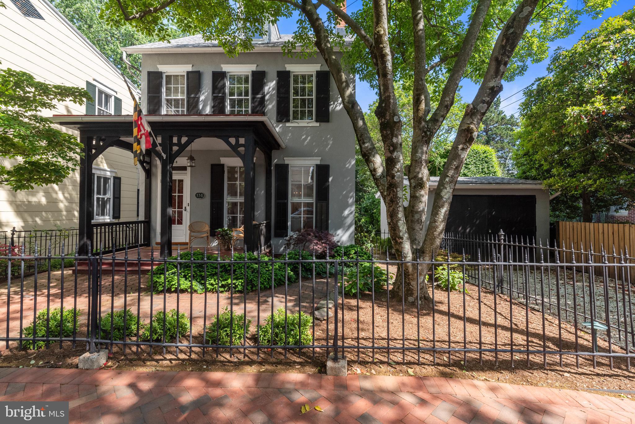Just Reduced! First time on the market in 40 years! This is a rare and special opportunity to own a detached home with both a garage and driveway in The Historic District of Downtown Annapolis.  This elegant home seamlessly blends gorgeous original details with modern updates on three finished levels. Wrought iron fence frames the home which is ideally set back on the lot and leads to the inviting and spacious front porch.  Entrance hall with its original staircase opens to the living room with built in shelves surrounding the gas fireplace.  The large living and dining rooms have oversized windows flooding the home with natural light and pocket doors which can separate the large open spaces.  The sunny kitchen and attached family rooms have been updated with a bar area, cherry cabinets, powder room and exotic granite making it the ideal place to gather around the gas fireplace.  Step into the sunroom from the kitchen for dining or lounging and admire the landscaped backyard that big enough to host a nice-sized party. 2nd and 3rd floors have spacious bedrooms and include an en-suite primary. All of this just a few short blocks to Main Street and a picturesque waterfront park where you can sit and read a book,  hop on the water taxi or drop your kayak in Spa Creek.  The perfect home for your perfect Annapolis life!