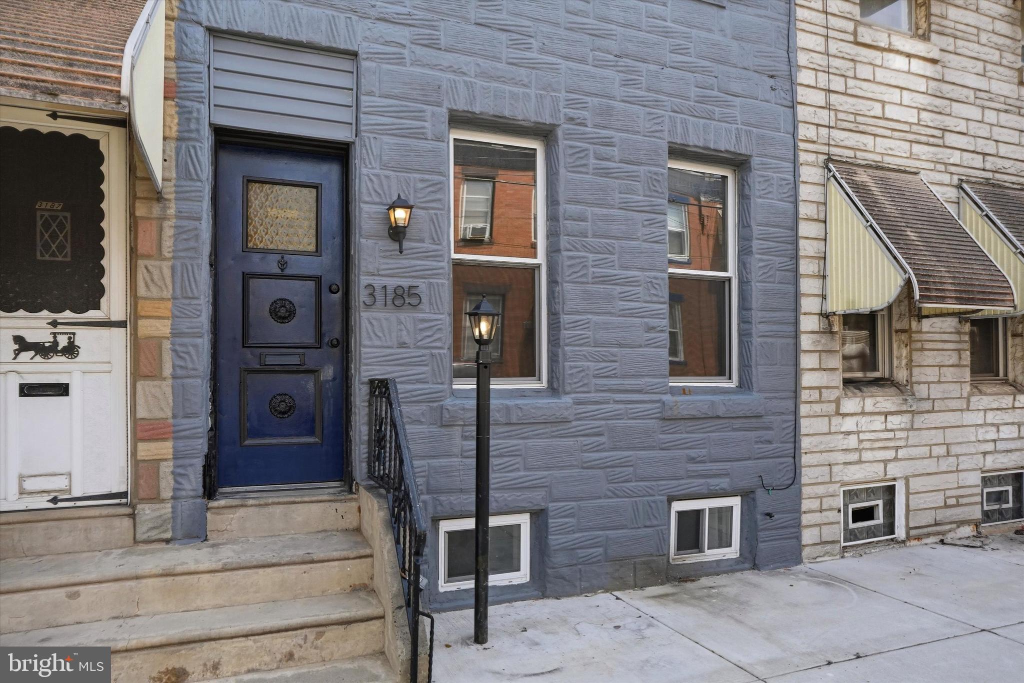 **STYLISH 3 BED/1.5 BATH IN PORT RICHMOND WITH FINISHED BASEMENT AND PATIO** This home is modern, fresh and full of details that make it special and unique. Exposed brick, reclaimed wood decorative wall and original iron railings: Check! Enter to the open living and dining floorplan just awaiting your personal furniture arrangement. A remote operated fireplace creates a cozy atmosphere and a nice base for your mounted TV (mounted holes pre-drilled). There is a bright modern half bath with wood vanity for ease of entertaining and daily life. The kitchen is a true standout with navy and white cabinets, gold fixtures, stainless steel appliances and counterspace galore! Beyond the kitchen is a good sized fenced in patio with level concrete ready for a grill, table, chairs and planters. Create your outdoor retreat! Upstairs are 3 true bedrooms with nice closet space, bright windows and a full hallway bathroom with sleek tile, shower/tub combo and light up vanity mirror. As a bonus the basement is mostly finished and provides additional space for a den, home office or whatever you envision. Located 1 block from Aramingo Avenue and near I-95 this home is close to everything you need and just a short distance to all else the City offers. Schedule your showing today or call for a private tour! 1 Year home warranty offered at closing from HWA.
