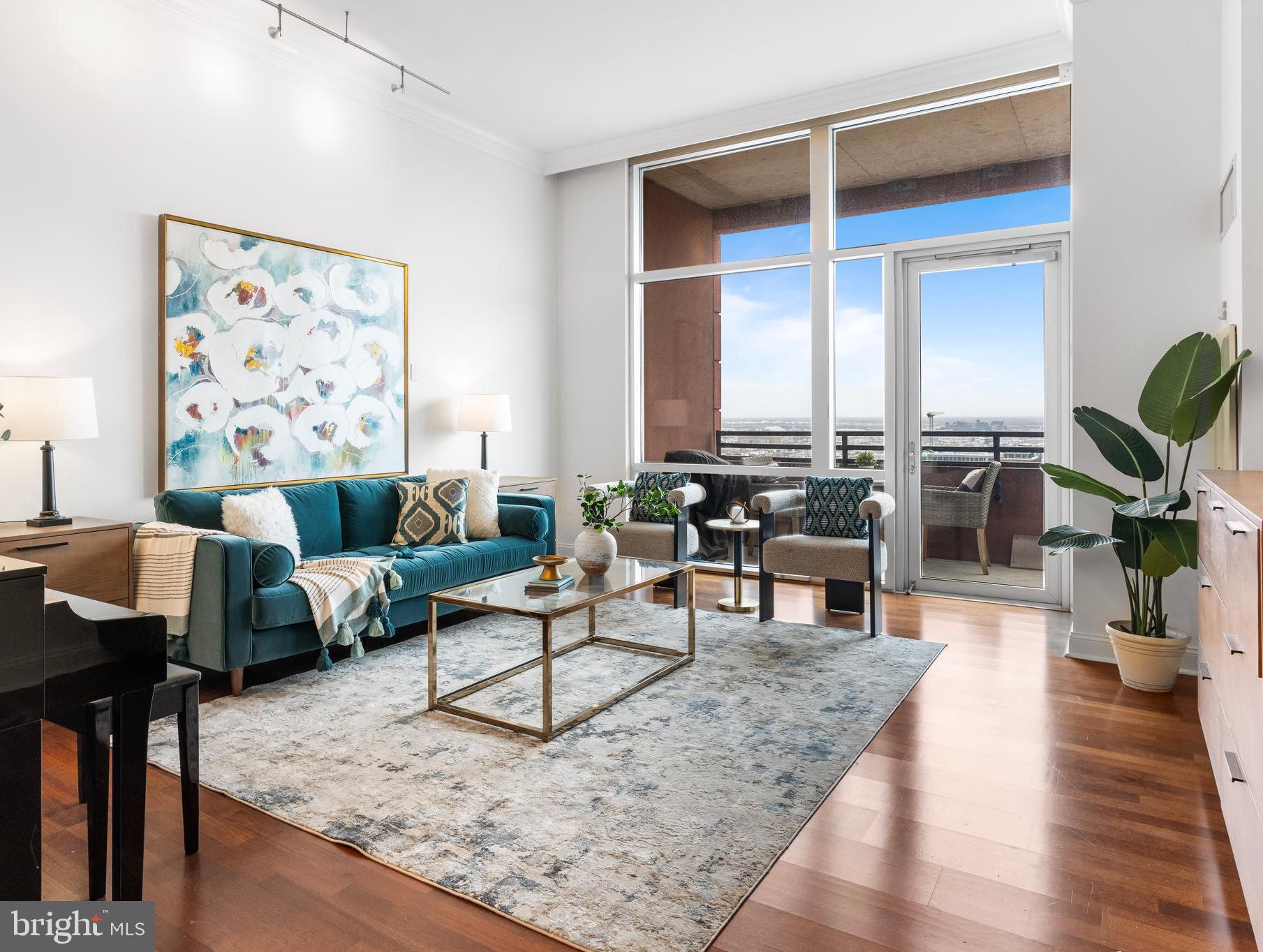 Arriving home to Suite 2702, you're instantly awed by the soaring twelve foot ceilings and the incredible amount of natural light.  This space is something special, and that feeling inspires each and every time you walk through the front door, that feeling of being home in the city.  This meticulous 1,826 square foot three bedroom, 3.5 bath residence has a true urban city vibe.  Smart, functional spaces, each beautifully detailed and with seamless flow.  The main live space is just the right comfortable proportions, flanked by an expansive floor to ceiling window that draws the outside canvas inside as living breathing artwork.  That gorgeous wide chink of blue sky.  Just one step to a spacious private open air balcony, perfect for a morning cappuccino and Wordle, or dinner under the stars.  From the towering 27th floor of Symphony House, you're almost touching them.  Inspired panoramic views, gorgeous fiery-red sunsets.  The perfect urban granite and stainless kitchen is compact but mighty, with plentiful countertops and cabinetry, pantry, breakfast bar, and a classic subway backsplash.   A convenient bar/coffee station with wine chiller elevates its focal niche in a meaningful way.   Elegant statement lighting fixtures, beautiful hardwood floors, wired for sound.  The primary suite is modern and calming, with an expansive expertly-fitted walk-in, linen, and luxurious marble bath with dual-sink, glass-enclosed shower and deep soak tub.  A lovely guest suite is bright and airy, with a modern marble en-suite bath and plentiful closets.  Adjacent the main live space, and key for seamless access and flow, the third bedroom easily transitions to expanded communal square footage for a home office or den with - yes - more desirable closet space, and a full en-suite marble bath.  All three bedroom suites are newly-carpeted a zen light grey, boasting oversized windows, and custom-fitted closets.  Off of the main gallery hall, which by the way is ideal for artwork, is a pocket door leading to a large room, equally incredible flex space for storage or cool fort with its elevated upper platform.  A modern marble half bath with chic lighting completes this incredible residence.  Did we mention the twelve foot ceilings?  Two garage spaces with a convenient EV charger in the building's private garage and a storage locker are included with the residence. Offering unparalleled services and amenities, prestigious Symphony House is the city's premier Avenue of the Arts address boasting 24/7 concierge and doorman, 65' heated indoor lap pool, steam and sauna, state-of-the-art fitness center, bike share, beautiful outdoor terraces, library, clubroom, dining salons, wine cellar and chef's catering facility. Stellar location, ideally situated amid the city's vibrant theatre district, steps from the finest restaurants, boutique shopping, recreation, major travel routes, the dynamic city lifestyle at your front door. A hallmark destination, Symphony House continues to enjoy incredible stability, and its well-earned status as one of the most prestigious buildings in the city.  Welcome home.