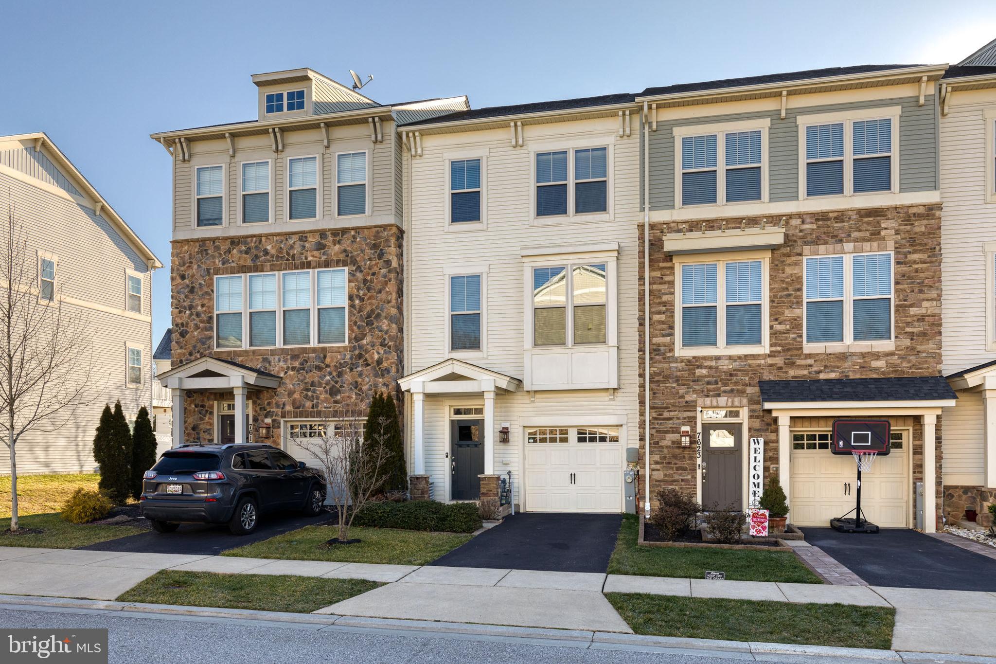 Live in luxury in the incredible Tanyard Cove North community.  This gorgeous 1 car garage townhome has been freshly painted a neutral grey tone to please anyone's design style.  The first level has a half bath and giant open space for a rec room/game room/ gym/or family room space.  The possibilities are endless.  There is even a walk out to the fenced backyard!   The next level of the home has a separate living room space that opens up to the expansive kitchen and dining area.  The kitchen is truly a chef's dream with an elongated center island, miles of cabinet and counter space, stainless steel appliances, granite counters, and custom built ins for added pantry space, wine storage, and even a beverage fridge.  There is even space for coffee nook! Enjoy relaxing in your primary suite with a private bathroom and lots of closet space.  The additional 2 bedrooms are spacious with great closet space.  There is a deck that is begging for a summer BBQ.  Community amenities include: pool, tot lot, fitness center, water privileges, and community center!