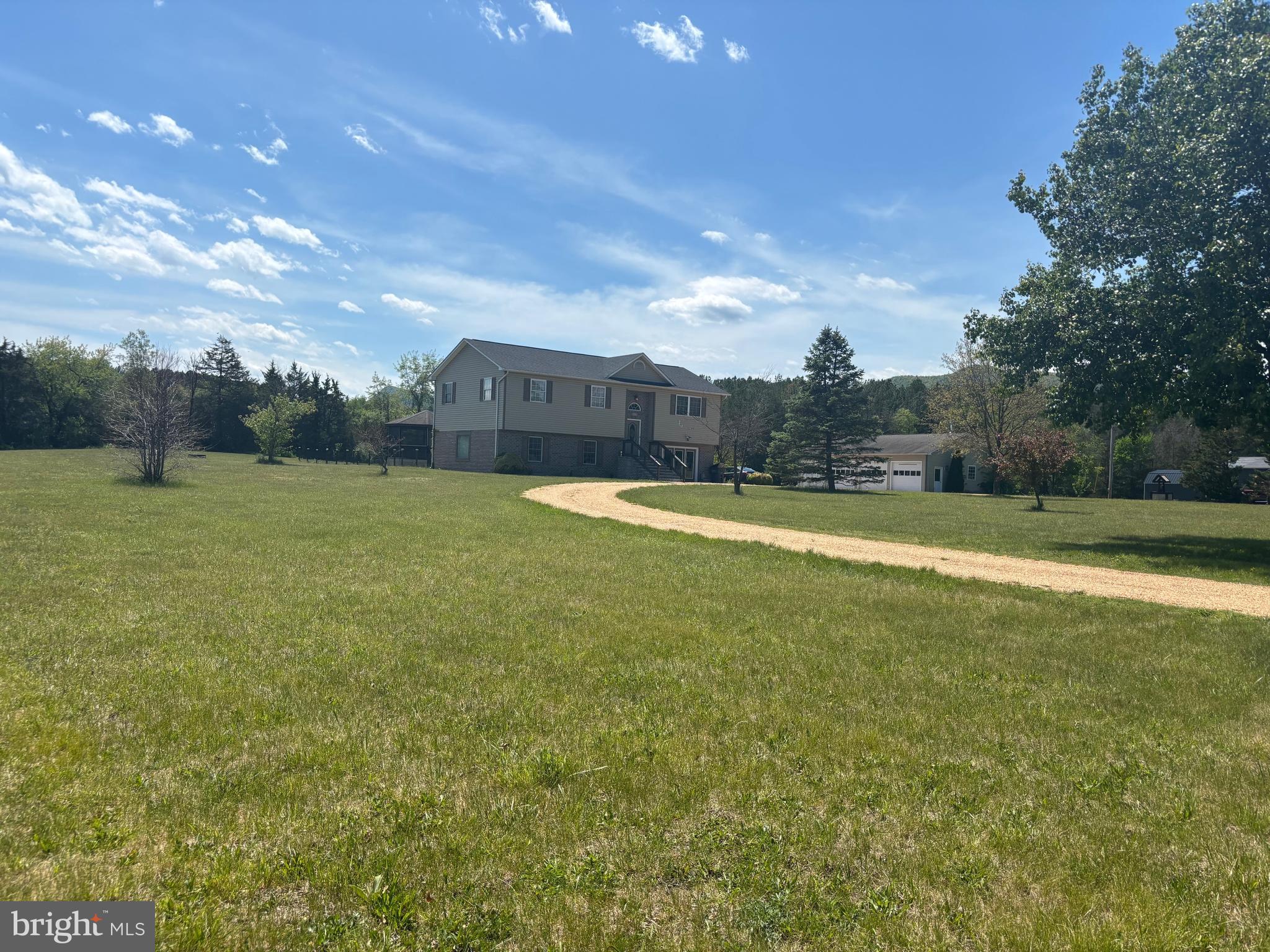 If you’ve been looking for space to spread out, enjoy the outdoors, and still have access to community amenities, this beautifully maintained split foyer checks all the boxes. Situated on a level 3-acre lot with huge side and backyard space, this property offers the kind of room and freedom that’s hard to find.

Pull in by the circular stone driveway and feel right at home. The exterior features vinyl siding with brick accents, while inside you’ll find a fresh, updated feel with new paint throughout, new vinyl plank flooring in the bedrooms, baths, and lower level, plus bamboo flooring in the main living area.

The living room, dining area, and kitchen flow together beautifully, creating an inviting space for everyday living and entertaining. The kitchen/dining combo opens directly to a large back deck and gazebo, perfect for cookouts, relaxing evenings, or morning coffee.

The main level offers 3 bedrooms and 2 full baths, while the finished lower level adds flexibility with a 4th bedroom, office/den with French doors and abundant natural light, laundry room, half bath with room to expand, and a spacious family room with a corner stone fireplace. Additional windows were added to allow natural light to pour in.

A 4-car detached garage gives you room for vehicles, hobbies, storage, or workshop space. Major updates include a newer roof and updated HVAC system for added peace of mind.

And the lifestyle? Homeowners enjoy access to the North Fork of the Shenandoah River, community lake, and pavilion—perfect for kayaking, fishing, swimming, and enjoying the beauty of the valley.

Homes with this much space and charm don’t last long—schedule your private showing today!
Does the community offer river access?
Yes! Homeowners enjoy access to the North Fork of the Shenandoah River, ideal for kayaking, fishing, swimming, and relaxing outdoors.

Are the roads paved?
Yes, the subdivision features paved roads with easy access and no steep mountain driving.

What amenities are available in the community?
Residents enjoy a community pavilion, lake access, and river recreation areas, creating a peaceful outdoor lifestyle.

What updates have been made to the home?
The home features fresh paint throughout, new vinyl plank flooring, a newer roof, and updated HVAC.

What makes this neighborhood appealing?
The area offers a smaller community setting with a mix of established and newer homes, while still providing privacy and open space.