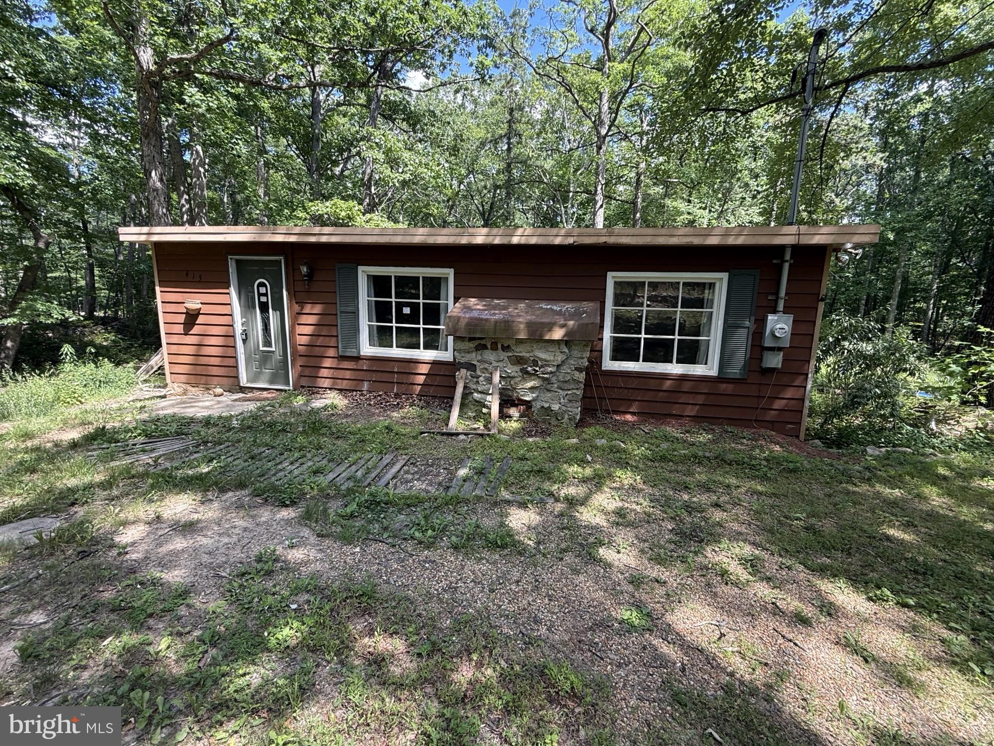 Ranch cabin-style home nestled in the woods on a private ½-acre lot.  Featuring 1-bedroom, additional room but not technically a bedroom, and 1 full bath, this property offers endless potential as a full-time residence, weekend retreat, or investment opportunity. Enjoy the tranquility of the wooded surroundings while remaining conveniently located just 25 minutes from Winchester. The home is served by a pump-and-haul septic system. Sold strictly As-Is.