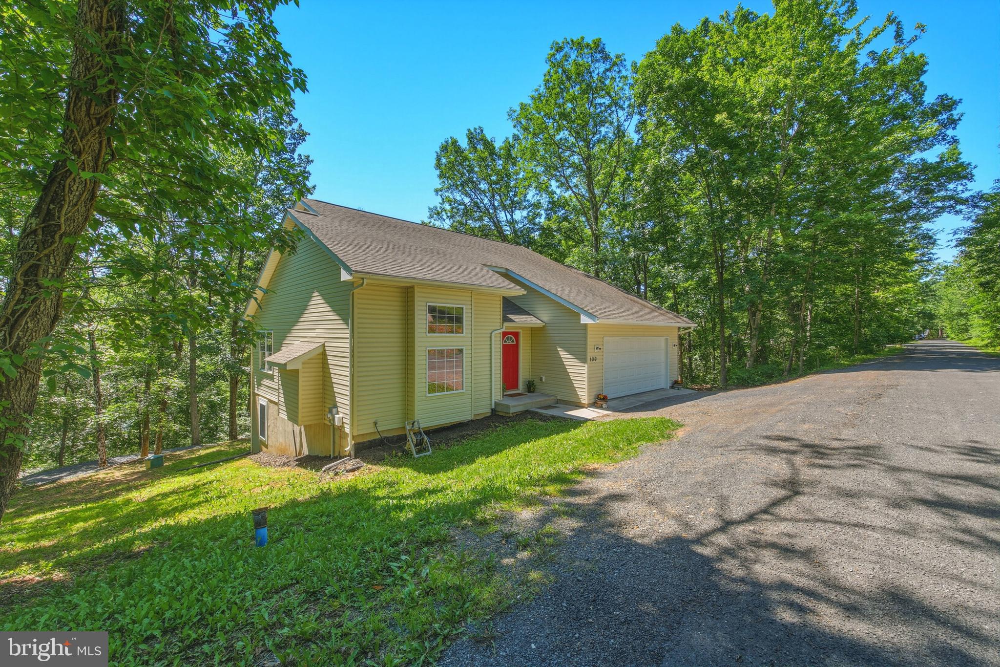 "My Getaway" Located just minutes from Bryce Resort, this spacious 3-bedroom, 2.5-bath home offers 2,706 square feet of comfortable living space along with a layout designed for both everyday living and entertaining. One of the standout features is the unique setup with a front-loading 2-car garage in addition to a separate rear driveway and parking area, providing plenty of room for guests and easy access. Outside, you'll also find inviting level areas in the backyard along with a firepit area perfect for gathering with family and friends.
Inside, vaulted ceilings create an airy feel throughout the main living and dining area, complemented by an open-concept kitchen and cozy gas fireplace in the living room. The main level also features a laundry area, convenient half bath, and spacious primary suite complete with a walk-in closet and ensuite bathroom featuring both a tub and separate shower. Upstairs, two generously sized bedrooms share a Jack-and-Jill style bathroom layout. The expansive basement offers incredible potential with abundant space for future finishing, recreation, or storage, and already includes plumbing rough-in for an additional bathroom. Major system updates include a new HVAC system and water heater, both replaced in 2024. Bryce Resort minutes away and offers the following: small airport, library, dog park, indoor pool, outdoor pool, lazy river, pickleball, tennis, playground, 18-hole golf, course, mini golf, lake, mountain biking, skiing, snowboarding, ice-skating rink, and restaurants. 1.5 hours from NoVA. There is a farmers' market on Wednesdays during the summer. Call now for an appointment.