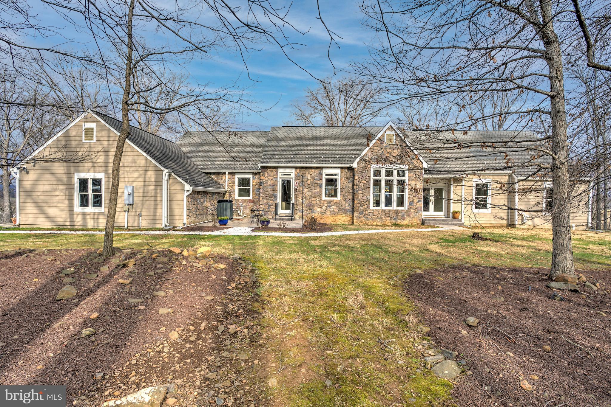 Rare Multi-Generational  Estate on 13 Private Acres with sweeping valley views! Discover two independent homes just 3 miles from Purcellville. The Main Residence (c2007)  has 4 BR & 5 full baths. Gleaming Oak hardwoods, and a chef’s kitchen with Cherry/Granite finishes. Designed for versatility, it features a rare ADA-compliant in-law suite and on the other end of the house  a luxurious Owner’s Wing. Enjoy the  walkout lower level with custom built-ins and a wet bar. Perfect for entertaining. The entire home has been freshly painted top to bottom, inside and out. New  carpet, a 17KW Generac generator.

The Guest Cottage: A charming 1900s farmhouse with log-addition (3BR/1BA) has a bit of Walnut cabinetry. Needs updating. Potential rental income $2k/mo.  or save it as a private guest home.

13 acres of absolute tranquility  cloaked by mature trees featuring stamped concrete patios and covered porch from which to enjoy the views. Enjoy total privacy without isolation—minutes from downtown, dining, and the W&OD Trail. The ultimate turn-key retreat!
