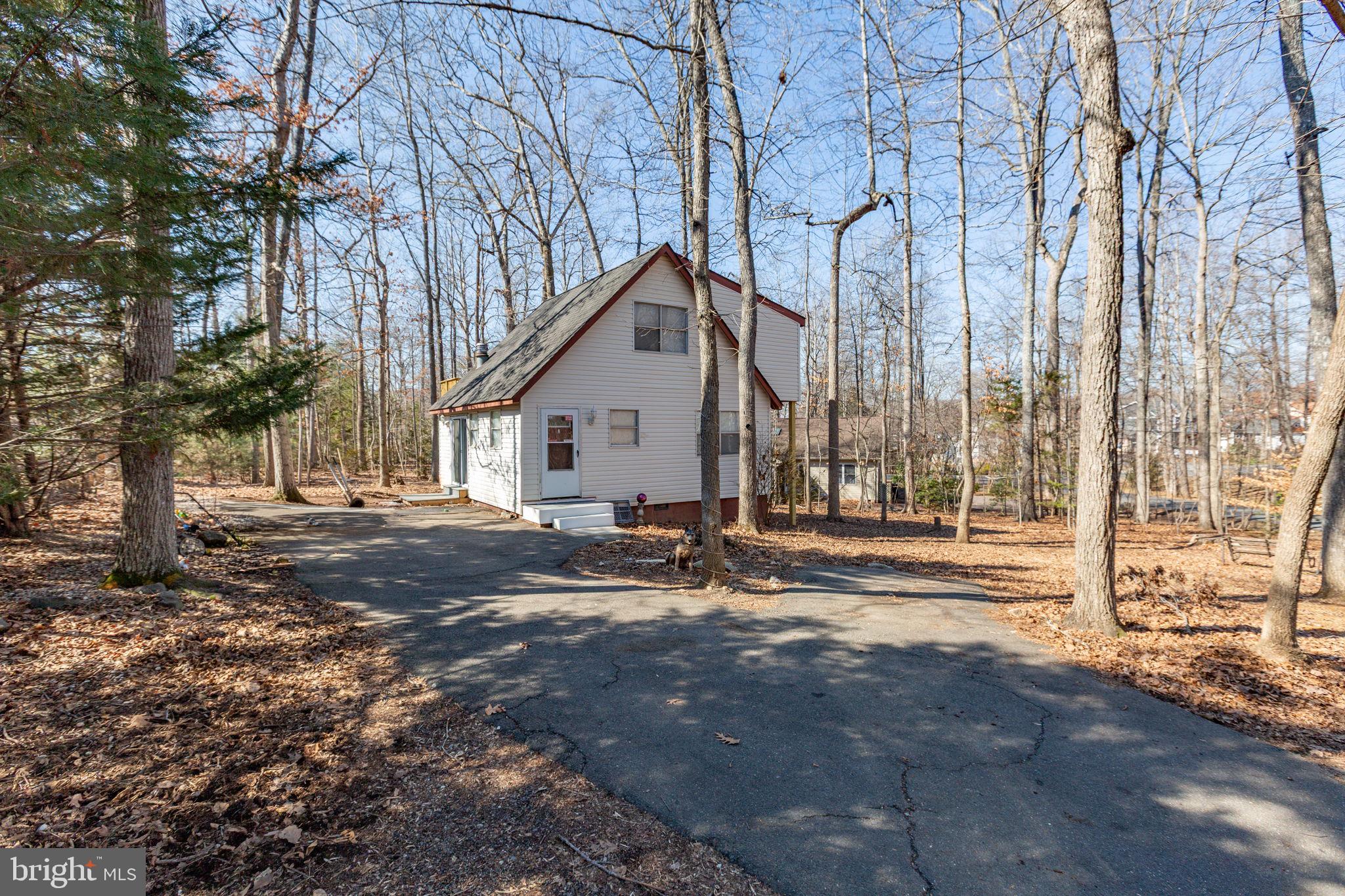 Welcome to easy, affordable lake living in Lake of the Woods! This home is updated, move-in ready, and priced under $300,000! At 104 Monticello Circle, the big-ticket items are already done for you. The roof was replaced 5 years ago and the HVAC was replaced a little over a year ago, offering peace of mind from day one. Inside, you’ll find freshly updated LVP flooring, fresh paint, a stylish brick accent wall that adds warmth and character, and a newly refreshed deck! The layout is flexible and functional, perfect for first-time buyers or those seeking a weekend lake retreat. The main level includes a kitchen with nice counter & cabinet space, comfortable bedroom, full bath, and open living/dining spaces. Upstairs, two generously sized bedrooms with LVP flooring share a Jack-and-Jill bath. One bedroom offers a walk-in closet, while the other opens to an elevated deck with peaceful treetop views with the perfect spot for morning coffee or unwinding at the end of the day. Outside, enjoy a charming garden-style front yard, a half-moon driveway with ample parking, and a lovely backyard. A newer side patio adds both function and charm, complemented by a beautiful Japanese maple for seasonal color. Located inside amenity rich Lake of the Woods, residents enjoy access to two lakes, beaches, pool, golf, equestrian trails, parks, dining and more, truly a lifestyle, not just a home. The Wilderness Battlefield entrance is less than five minutes away, with Route 3 shopping and dining within ten. Fredericksburg, Orange, and Culpeper are all within a 30-minute drive. Whether you're buying your first home or searching for an affordable lake escape, this thoughtfully updated retreat offers comfort, community, and everyday ease, all at a price point that’s increasingly hard to find.