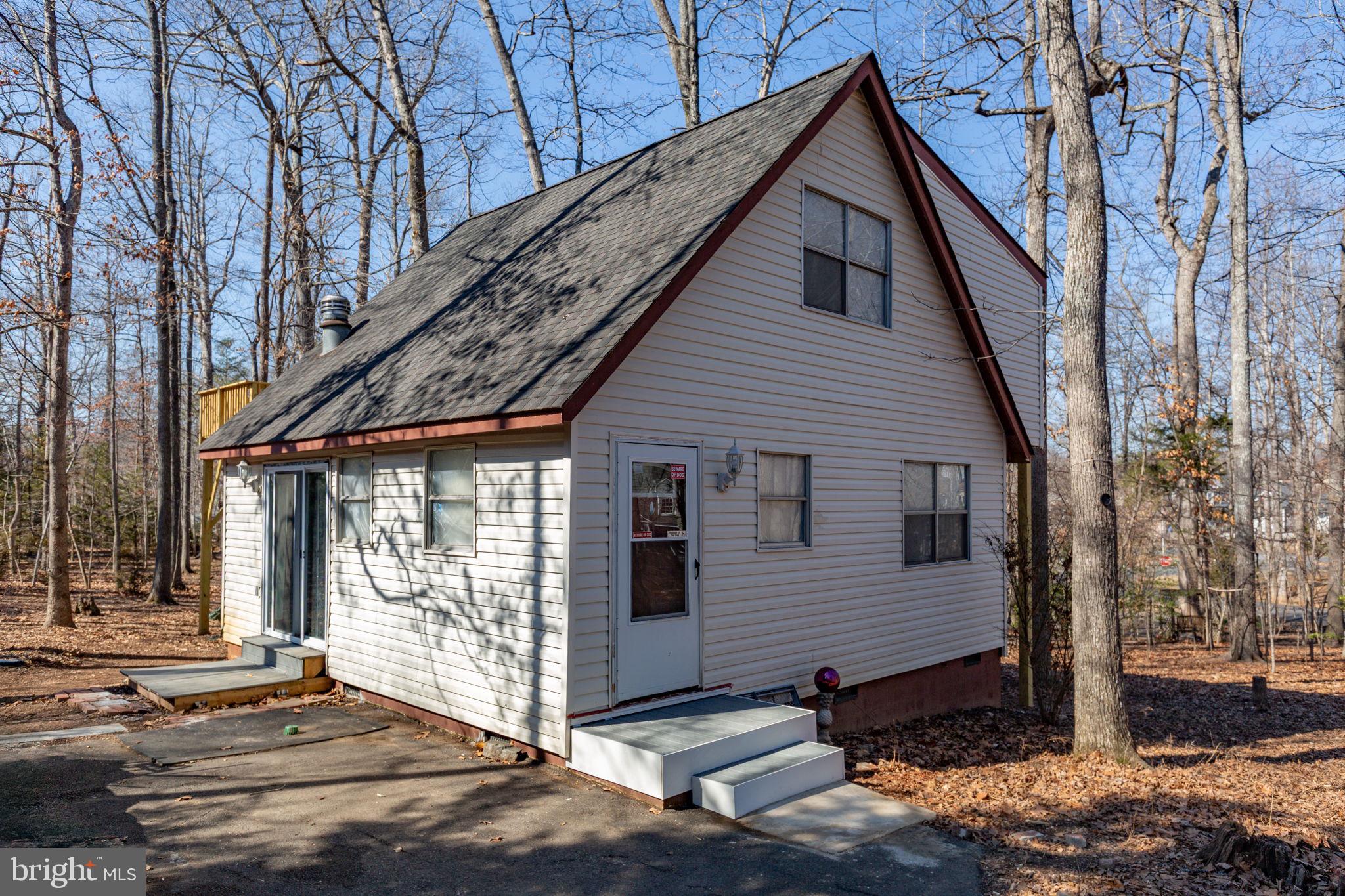 Welcome to easy, affordable lake living in Lake of the Woods! This home is updated, move-in ready, and priced under $300,000! At 104 Monticello Circle, the big-ticket items are already done for you. The roof was replaced 5 years ago and the HVAC was replaced a little over a year ago, offering peace of mind from day one. Inside, you’ll find freshly updated LVP flooring, fresh paint, a stylish brick accent wall that adds warmth and character, and a newly refreshed deck! The layout is flexible and functional, perfect for first-time buyers or those seeking a weekend lake retreat. The main level includes a kitchen with nice counter & cabinet space, comfortable bedroom, full bath, and open living/dining spaces. Upstairs, two generously sized bedrooms with LVP flooring share a Jack-and-Jill bath. One bedroom offers a walk-in closet, while the other opens to an elevated deck with peaceful treetop views with the perfect spot for morning coffee or unwinding at the end of the day. Outside, enjoy a charming garden-style front yard, a half-moon driveway with ample parking, and a lovely backyard. A newer side patio adds both function and charm, complemented by a beautiful Japanese maple for seasonal color. Located inside amenity rich Lake of the Woods, residents enjoy access to two lakes, beaches, pool, golf, equestrian trails, parks, dining and more, truly a lifestyle, not just a home. The Wilderness Battlefield entrance is less than five minutes away, with Route 3 shopping and dining within ten. Fredericksburg, Orange, and Culpeper are all within a 30-minute drive. Whether you're buying your first home or searching for an affordable lake escape, this thoughtfully updated retreat offers comfort, community, and everyday ease, all at a price point that’s increasingly hard to find.